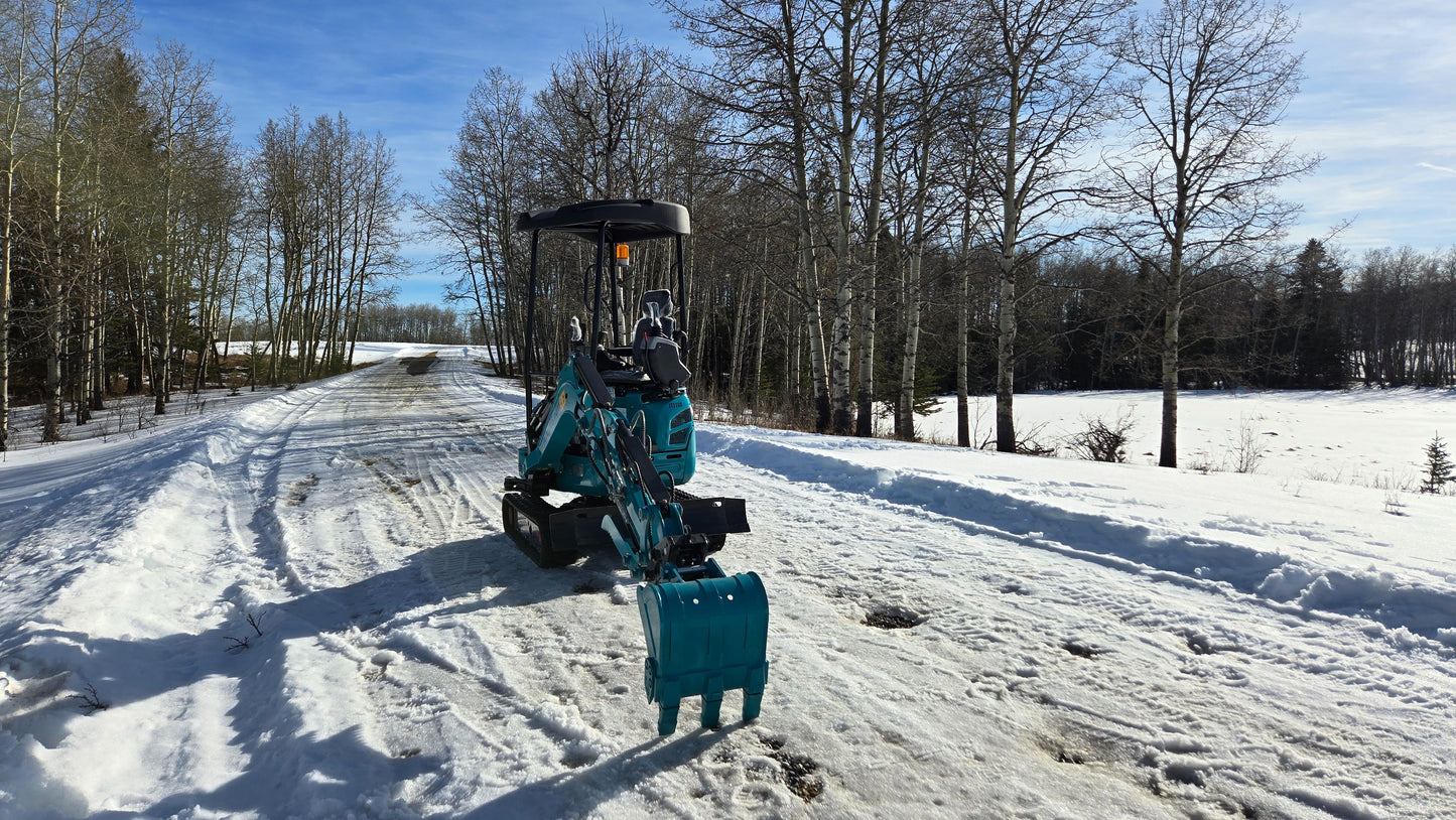 Rear angle view of JoyT5 JT5200 2 ton mini excavator with boom and bucket extended near the ground. Compact Kubota-powered digger ideal for trenching, landscaping, and construction projects.
