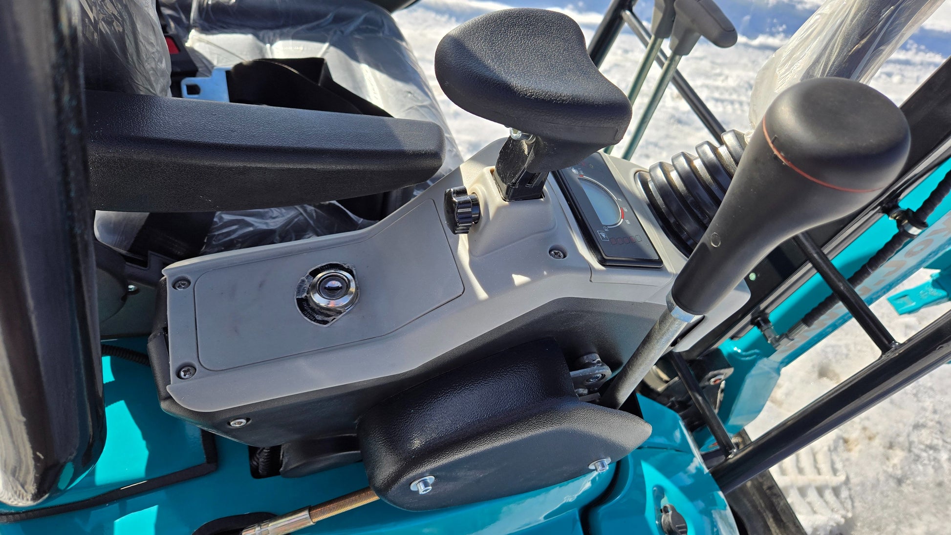 Ignition switch, throttle lever, and joystick control panel of JoyT5 JT5200 mini excavator for operator control and functionality.
