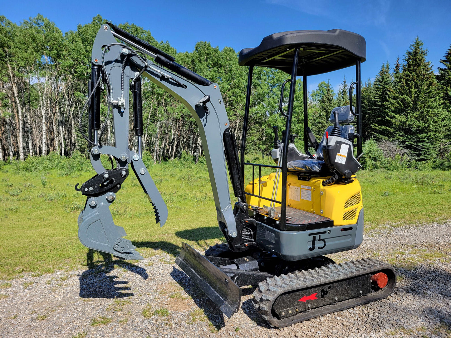 Front left angle view of JT5200 mini excavator with digging bucket, dozer blade, and hydraulic arm.
