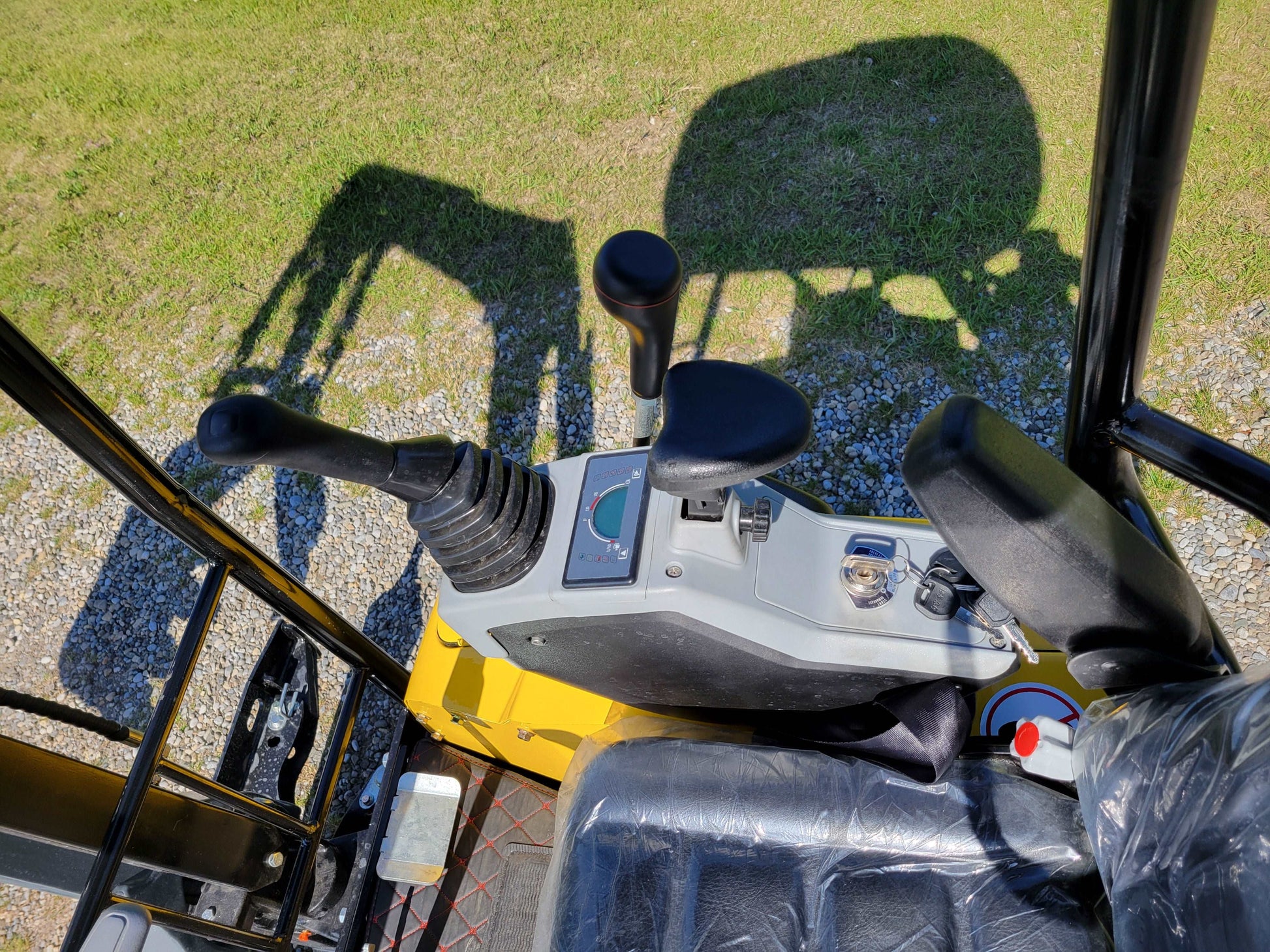 JT5200 mini excavator operator control area showing joystick, armrest, switches, and seat.
