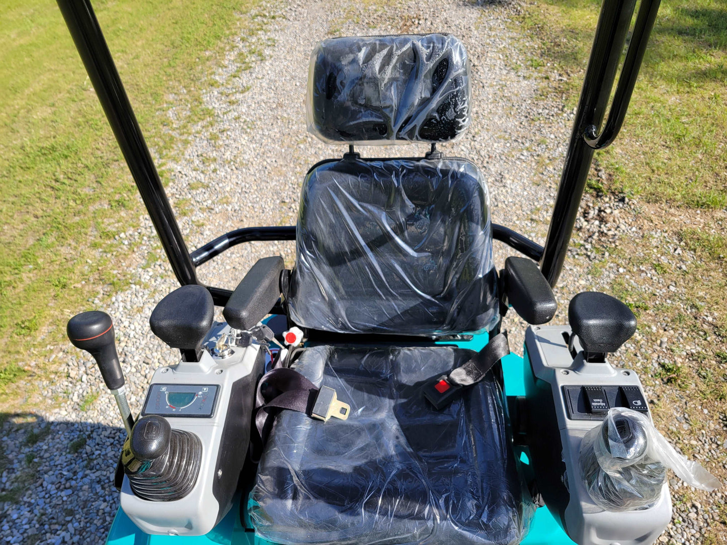 Operator seat and control panel with joysticks and safety belt in JT5200 mini excavator.
