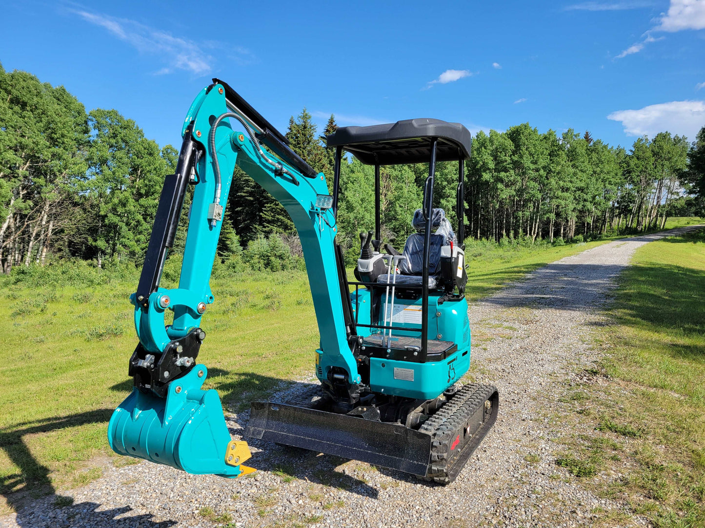 JT5200 mini excavator rear angle view showing operator seat, tracks, and digging bucket.
