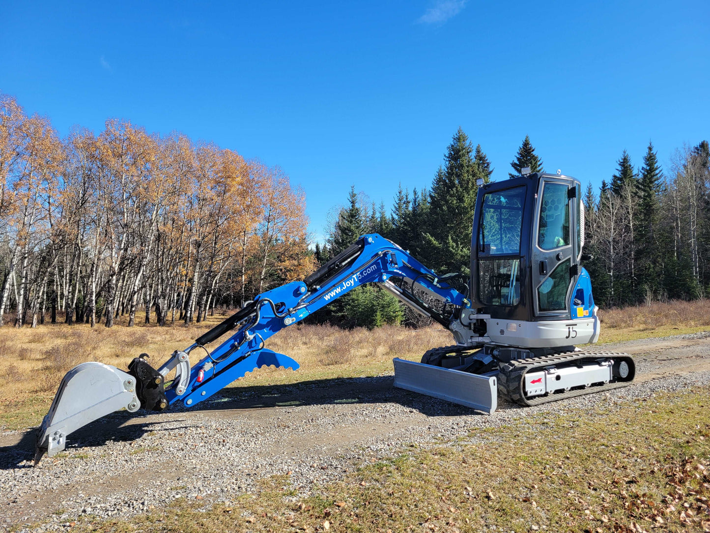 JT5350 3.5 ton mini excavator for sale in Canada powered by Kubota engine compact hydraulic excavator operating on gravel pathway surrounded by trees
