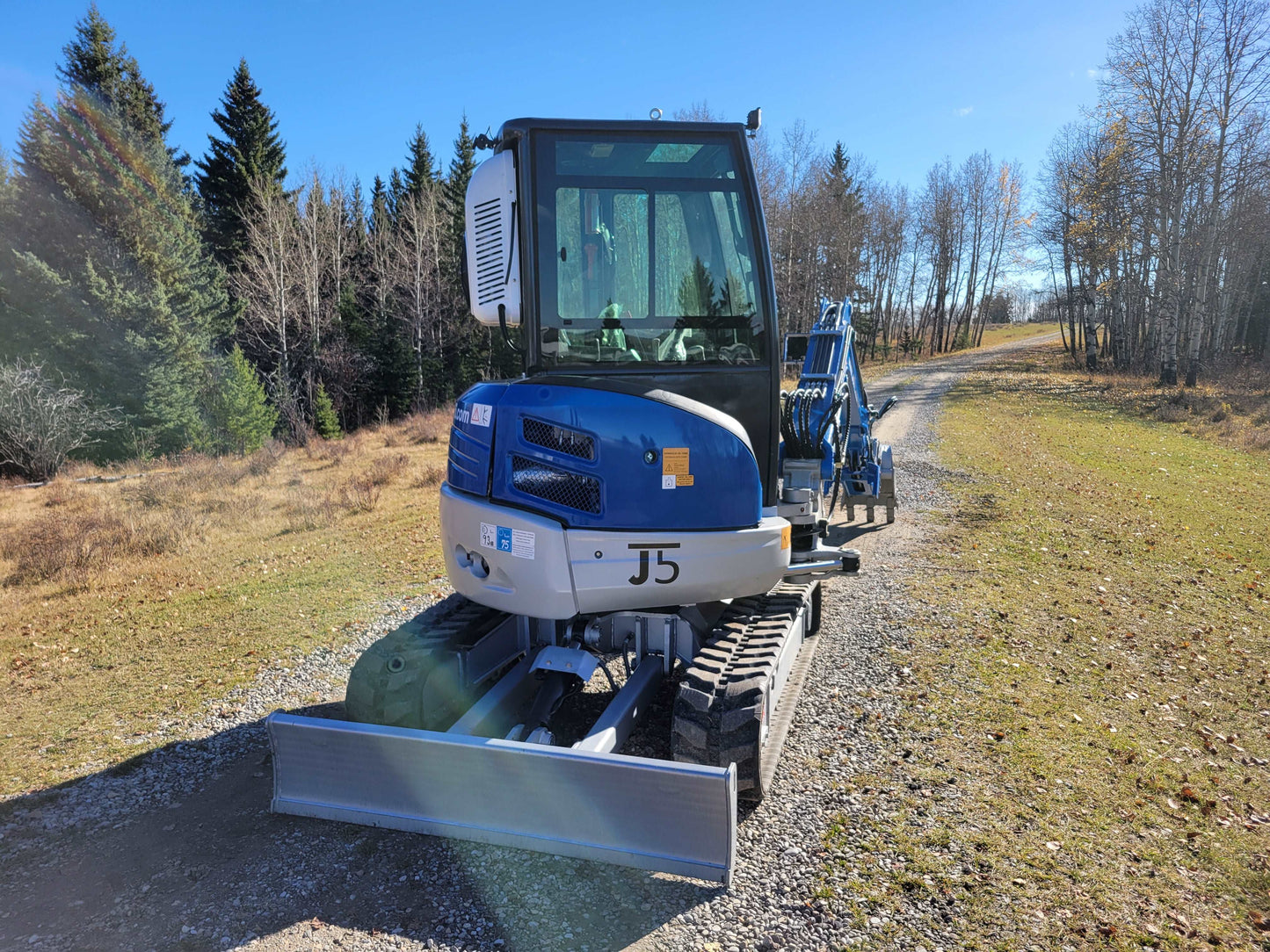 JT5350 3.5 ton mini excavator front view on gravel road in Canada JoyT5 compact construction excavator with dozer blade zero tail swing and cabin AC for contractors