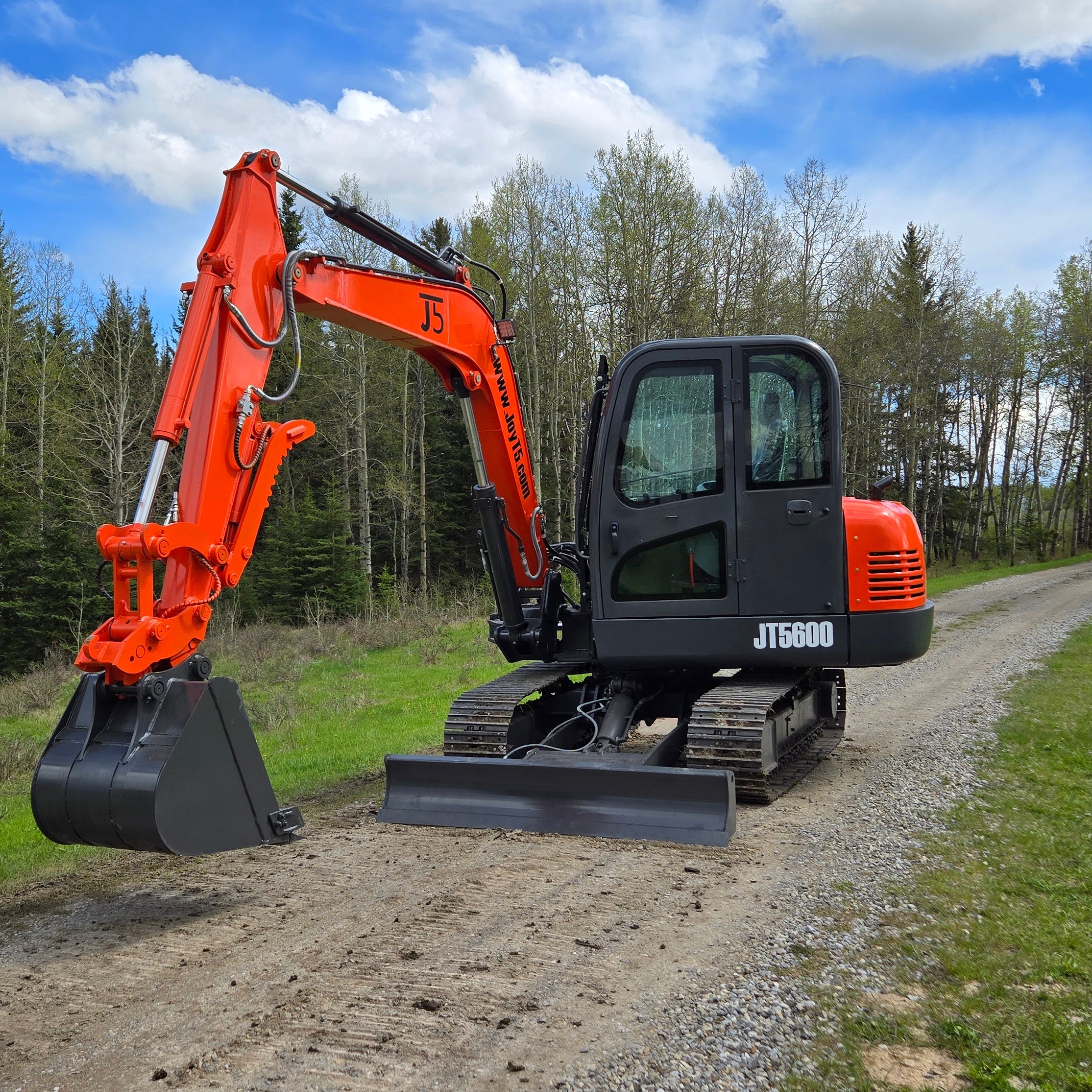 JT5600 6 Ton Mini Excavator for Sale in Canada with JoyT5 working beside rural road showing yanmar diesel compact excavator for construction projects and landscaping in Canada