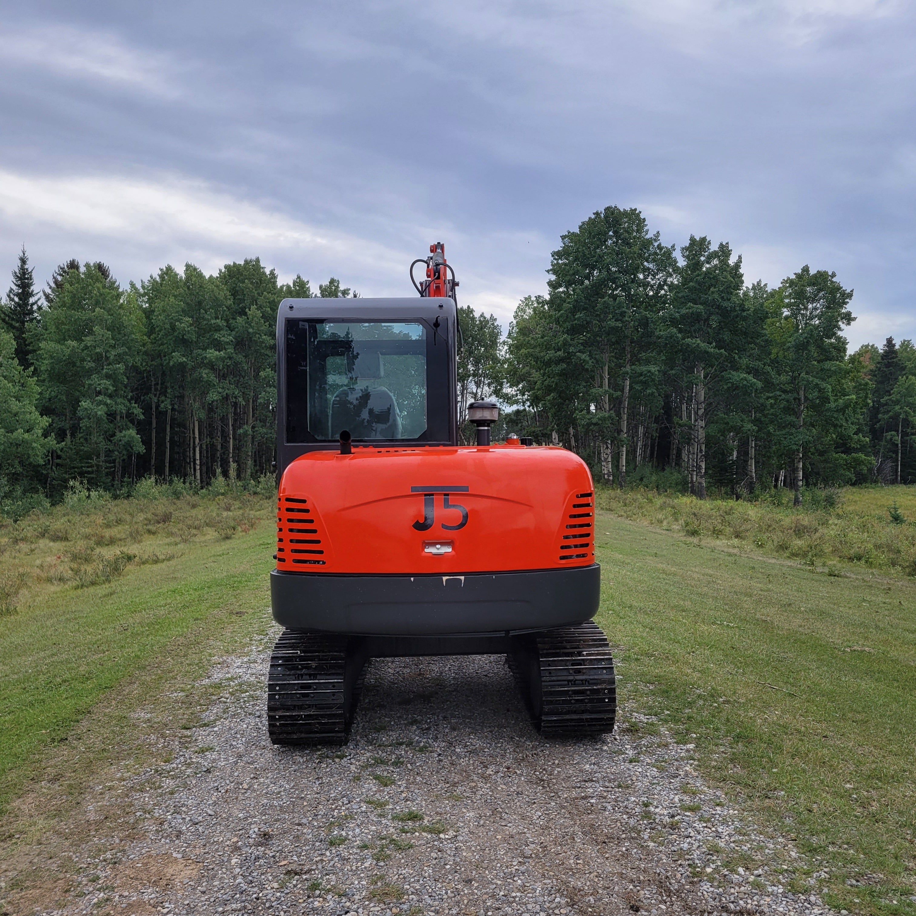 JT5600 6 ton mini excavator for sale in Canada powered by Yanmar engine rear view compact construction machine durable small excavator standing on field for landscaping and building use