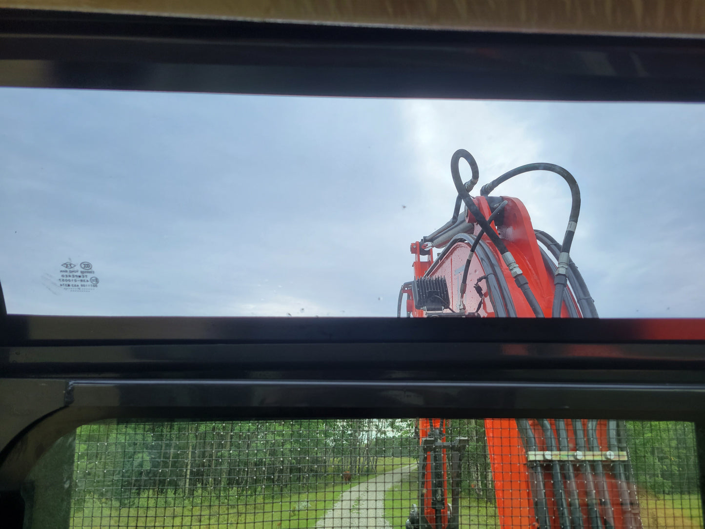 JT5600 6 ton mini excavator for sale in Canada powered by Yanmar engine cabin front window view showing boom and hydraulic lines compact construction equipment for landscaping projects

