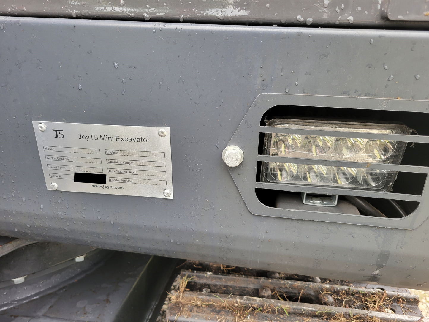 JT5600 6 ton mini excavator for sale in Canada powered by Yanmar engine close up of LED light and metal identification plate compact construction equipment durable design

