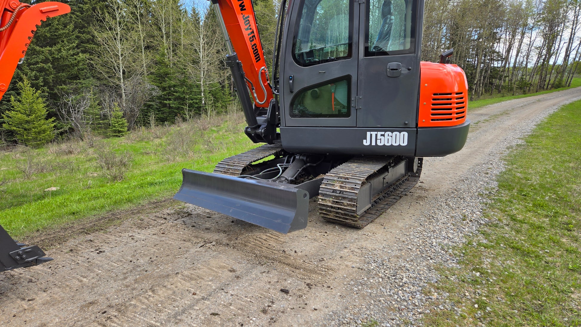 JT5600 JoyT5 6 ton mini excavator front view with dozer blade and rubber crawler tracks