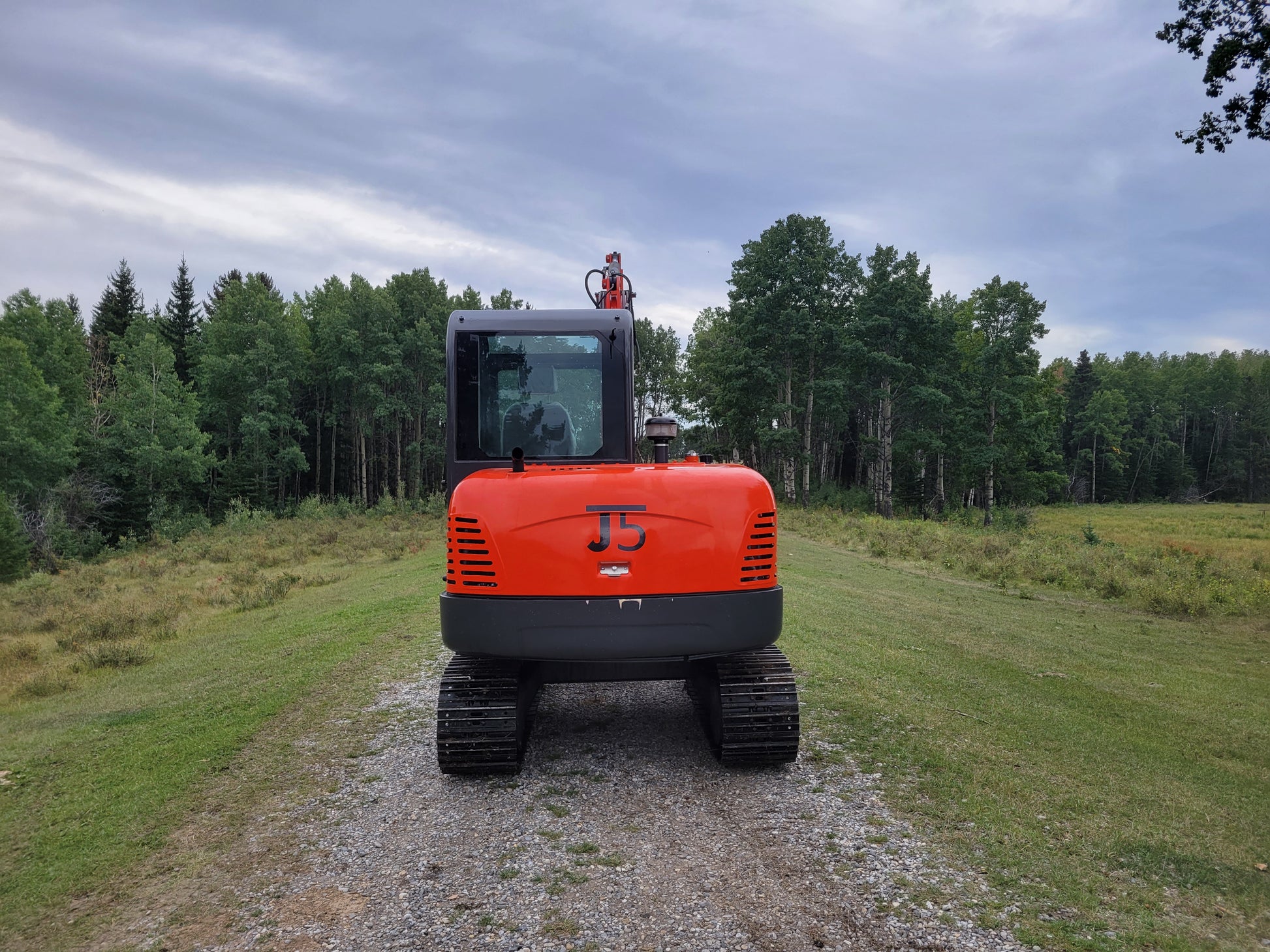 Rear view of JT5600 6 Ton Mini Excavator – JoyT5 crawler digger with Yanmar engine, cab AC, and heavy-duty tracks for construction