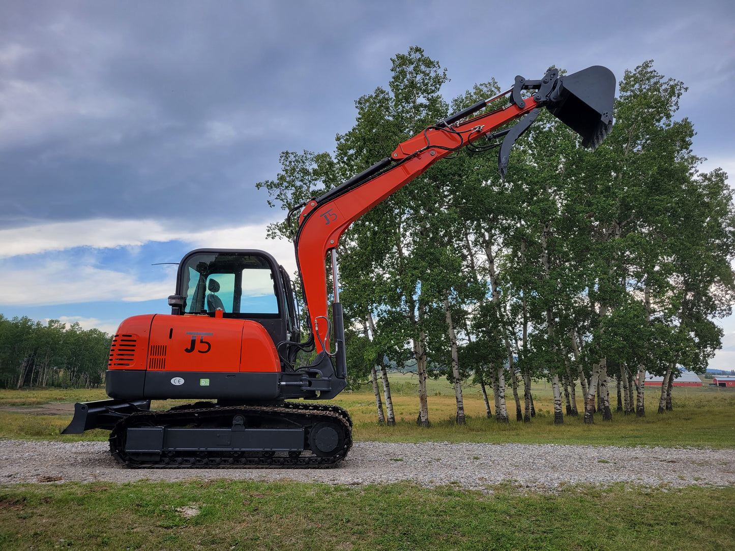 JT5600 6 Ton Mini Excavator side view with raised digging bucket – JoyT5 compact excavator powered by Yanmar engine with hydraulic quick hitch
