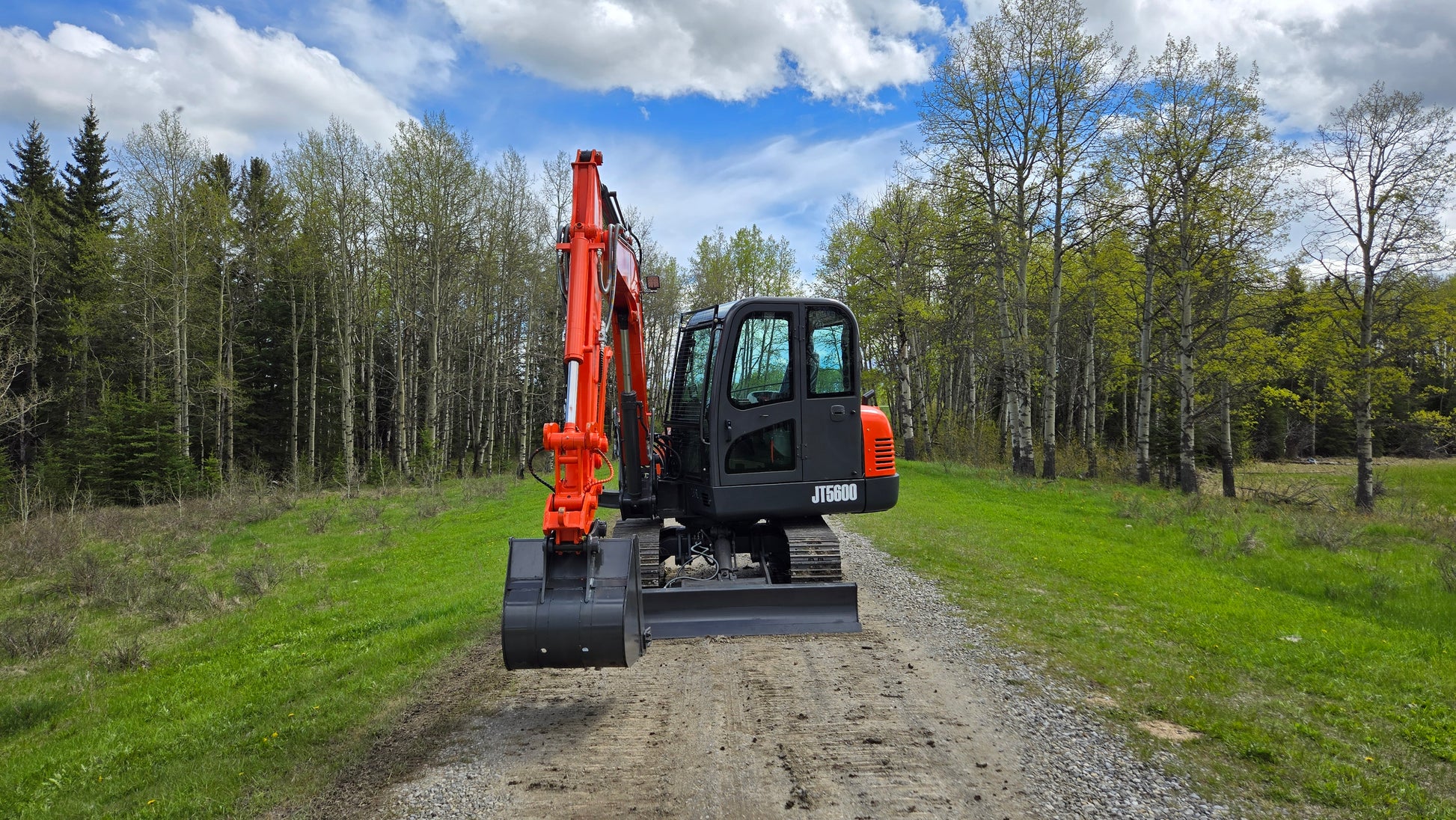 JT5600 6 Ton Mini Excavator for Sale | JoyT5 Yanmar Engine back view on gravel road with hydraulic quick hitch and side swing boom