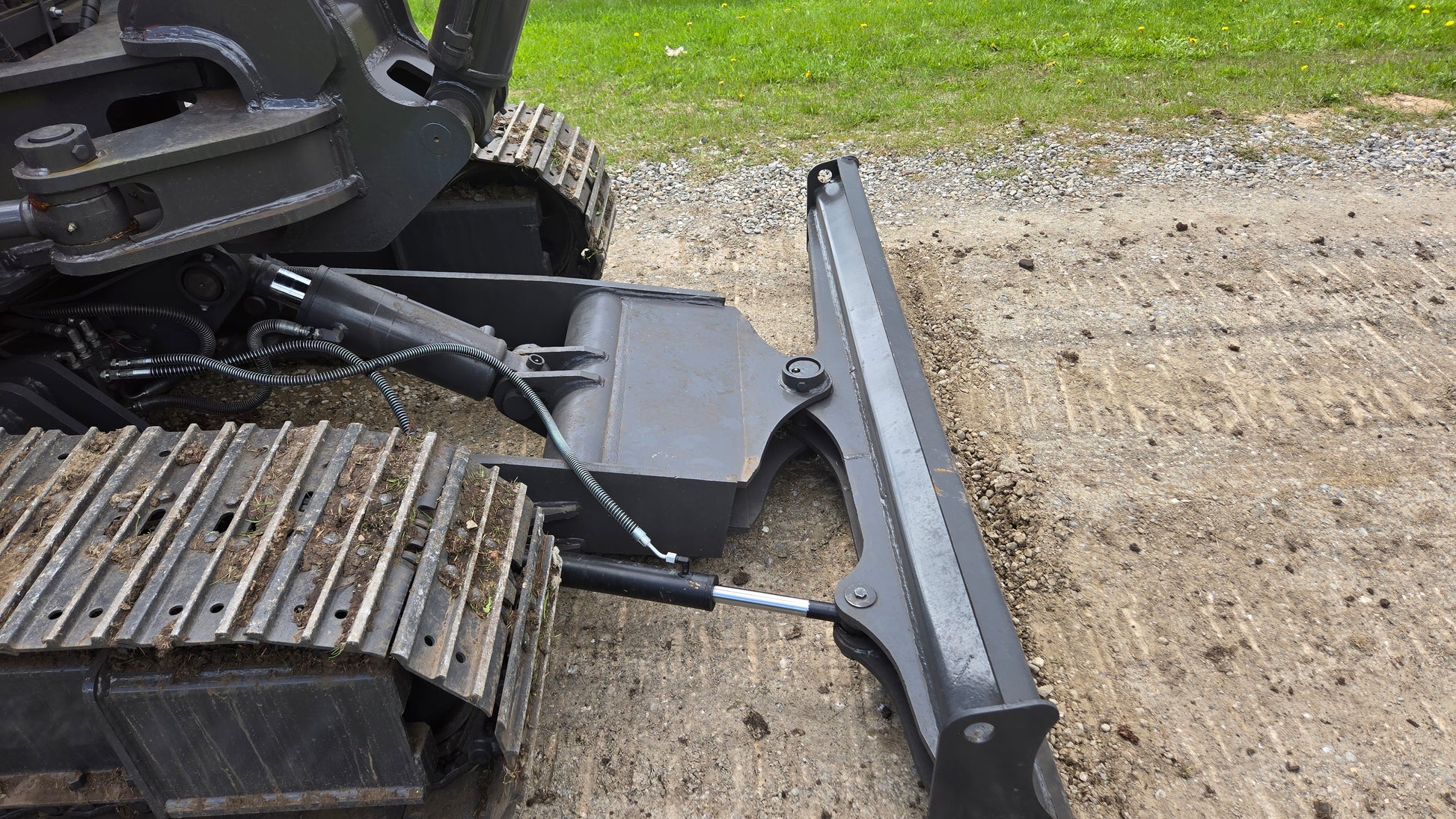 JT5600 mini excavator dozer blade close-up view on gravel ground
