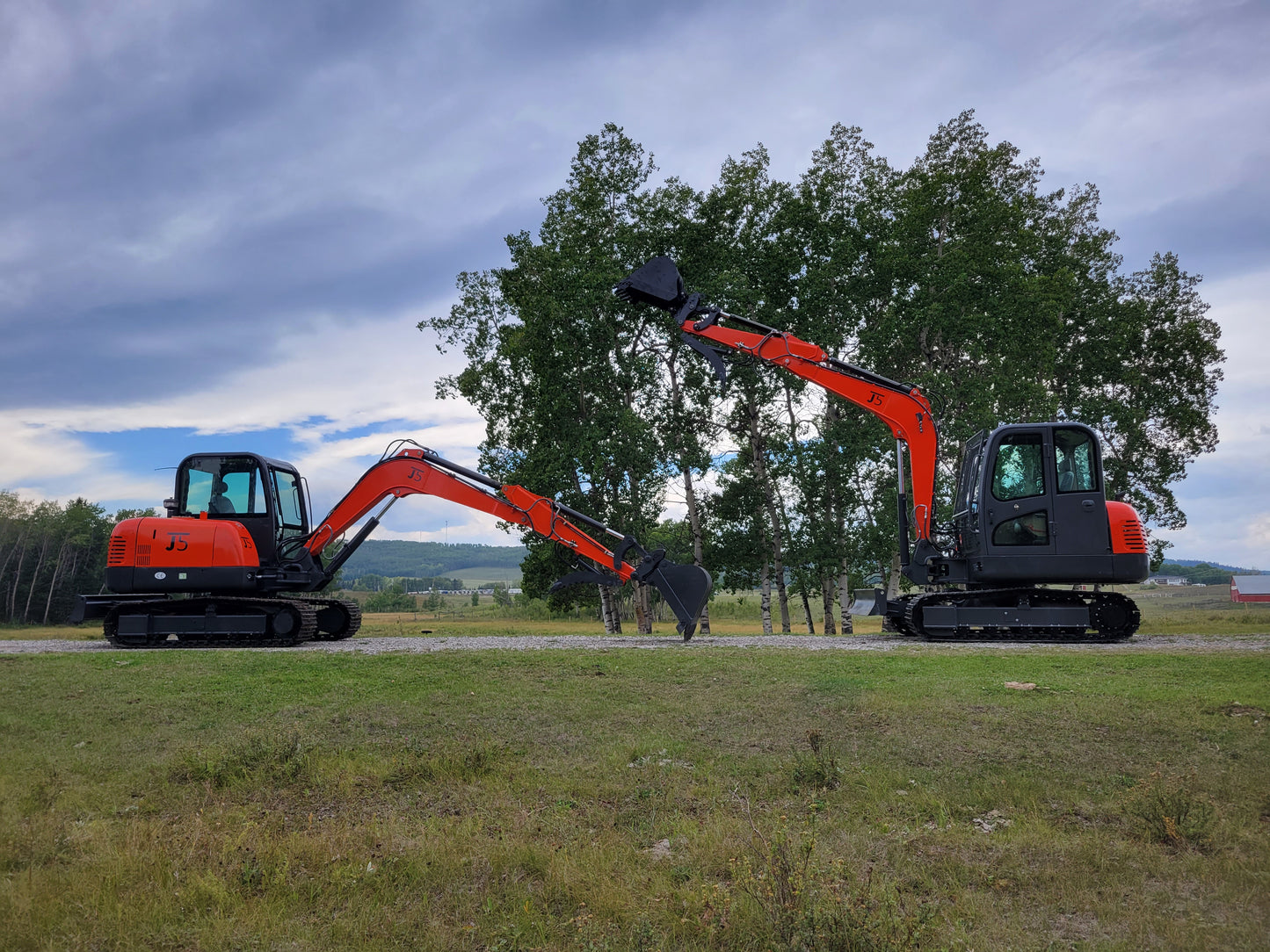 Two JT5600 mini excavators facing each other with long boom arms extended – JoyT5 6 ton excavator