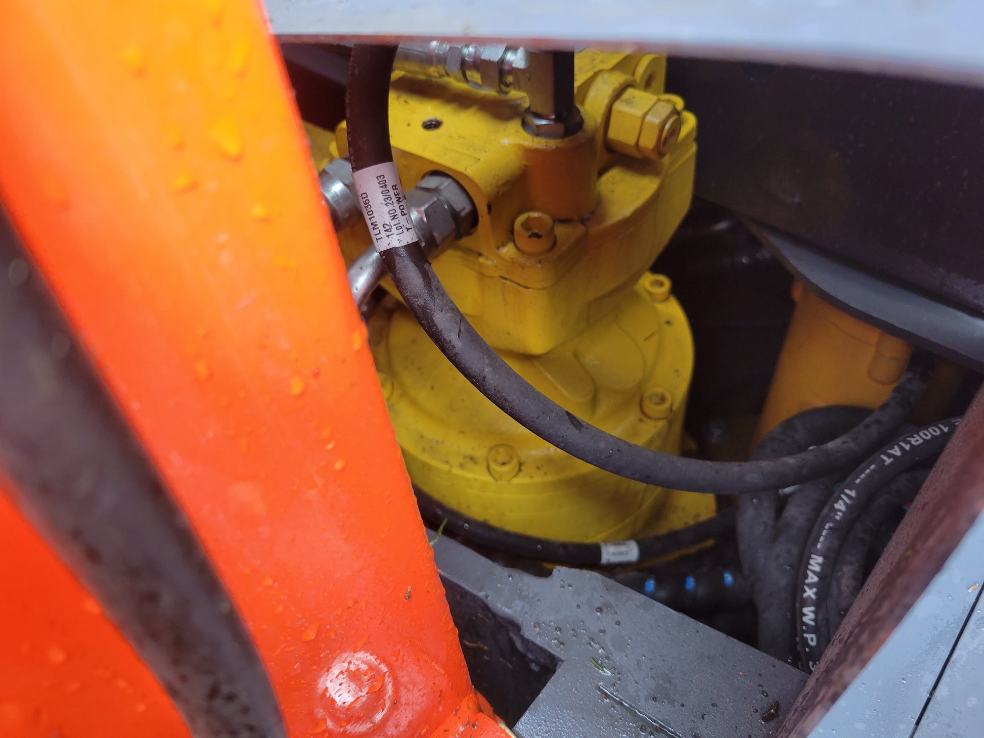 Close-up view of JT5600 Mini Excavator yellow hydraulic pump and hoses for smooth and efficient operation