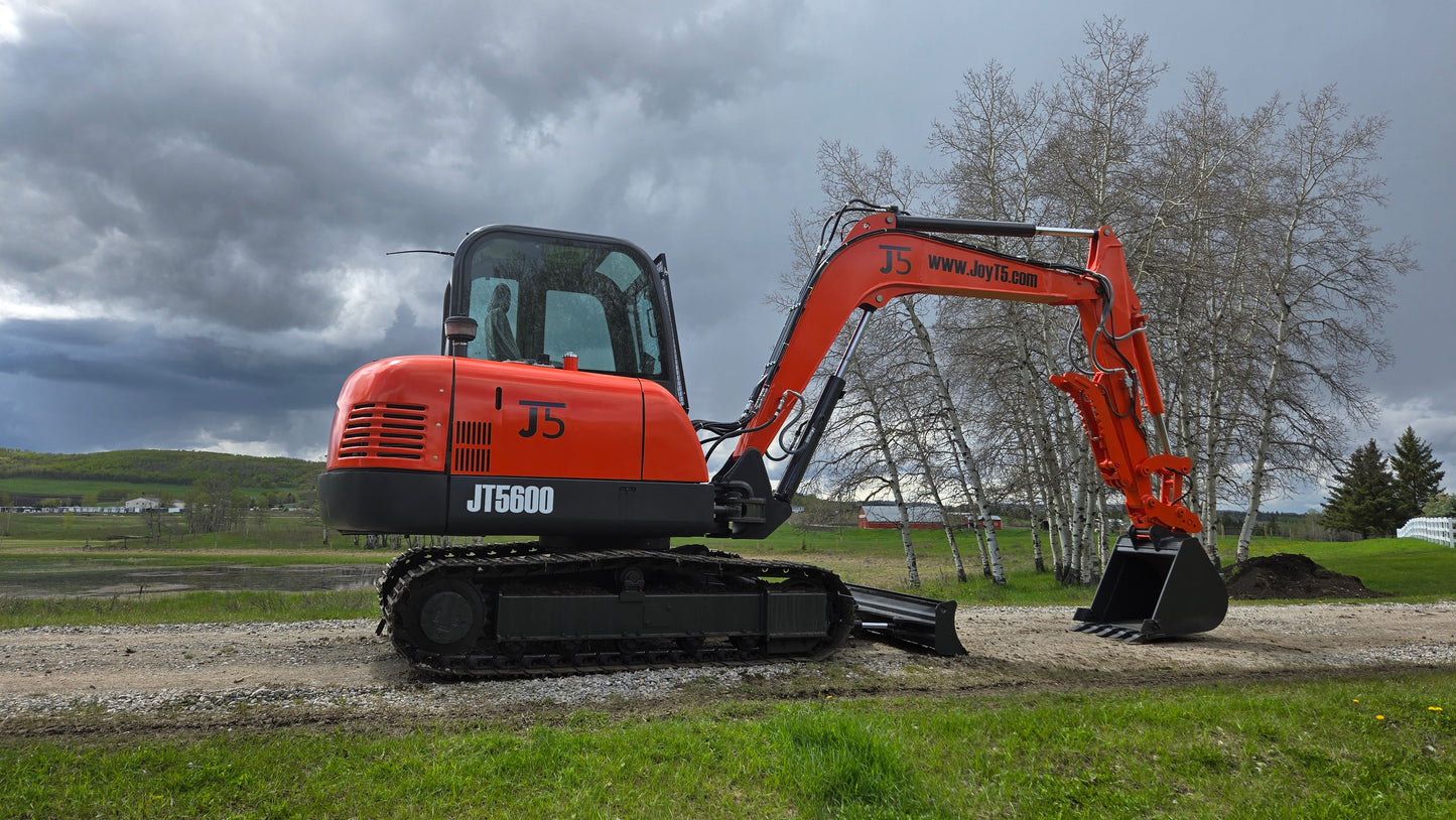 JT5600 JoyT5 mini excavator left side close-up with bucket lifted and dozer blade visible