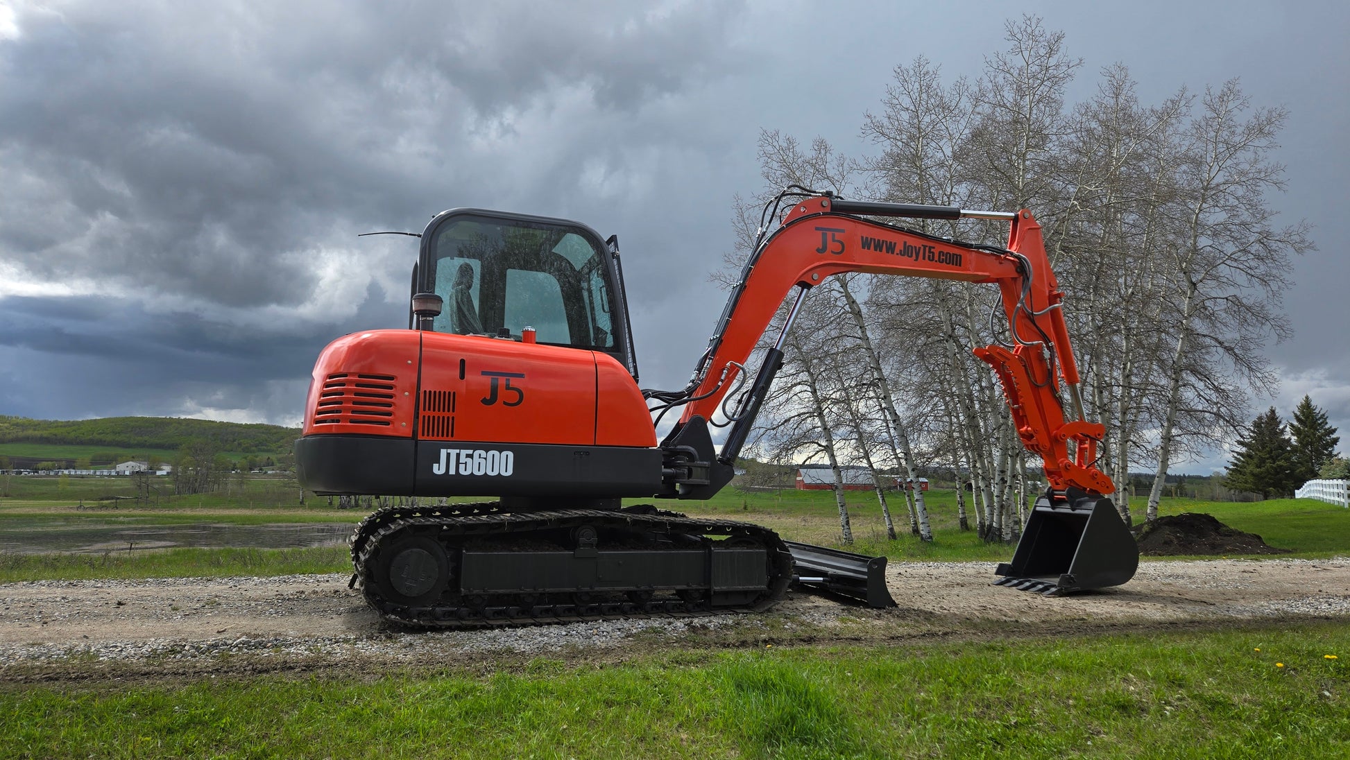 JT5600 JoyT5 mini excavator left side close-up with bucket lifted and dozer blade visible