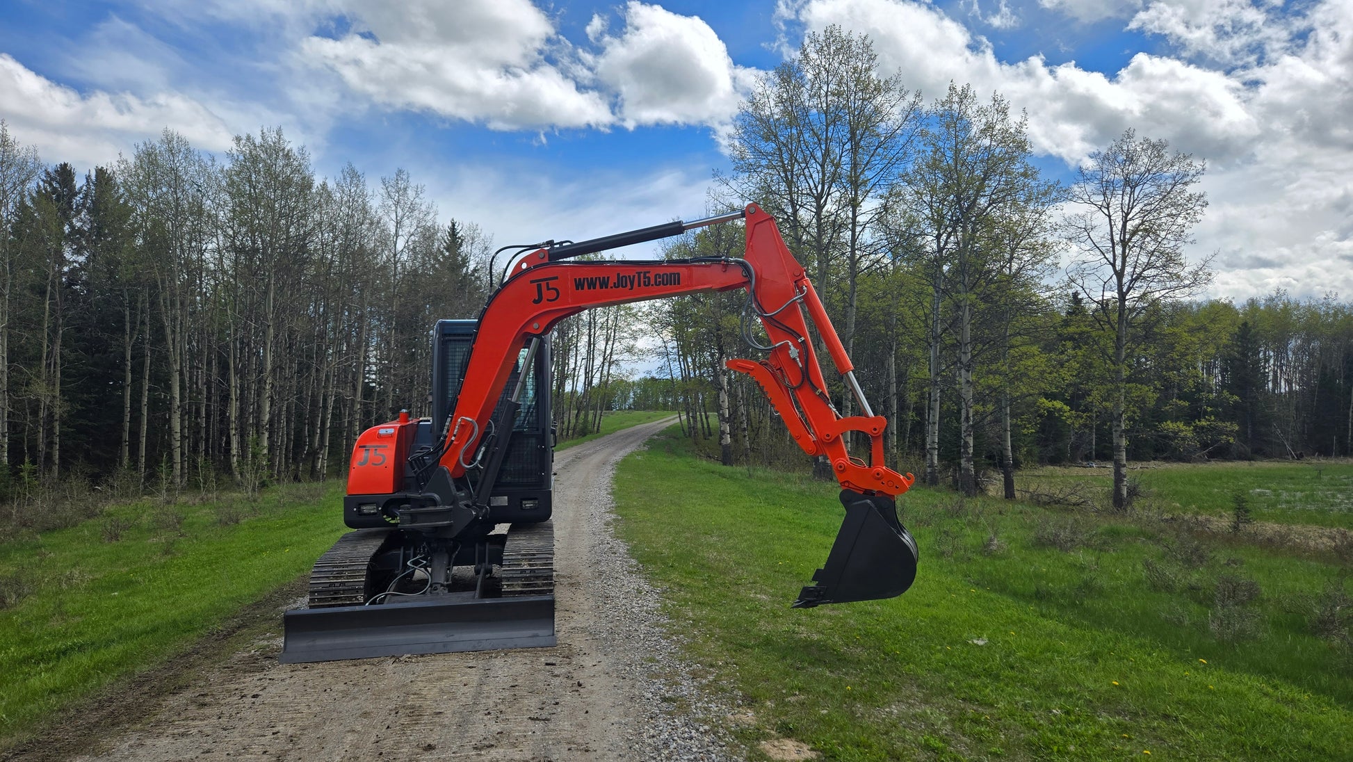 JT5600 Mini Excavator with extended side arm and digging bucket on rural path | JoyT5