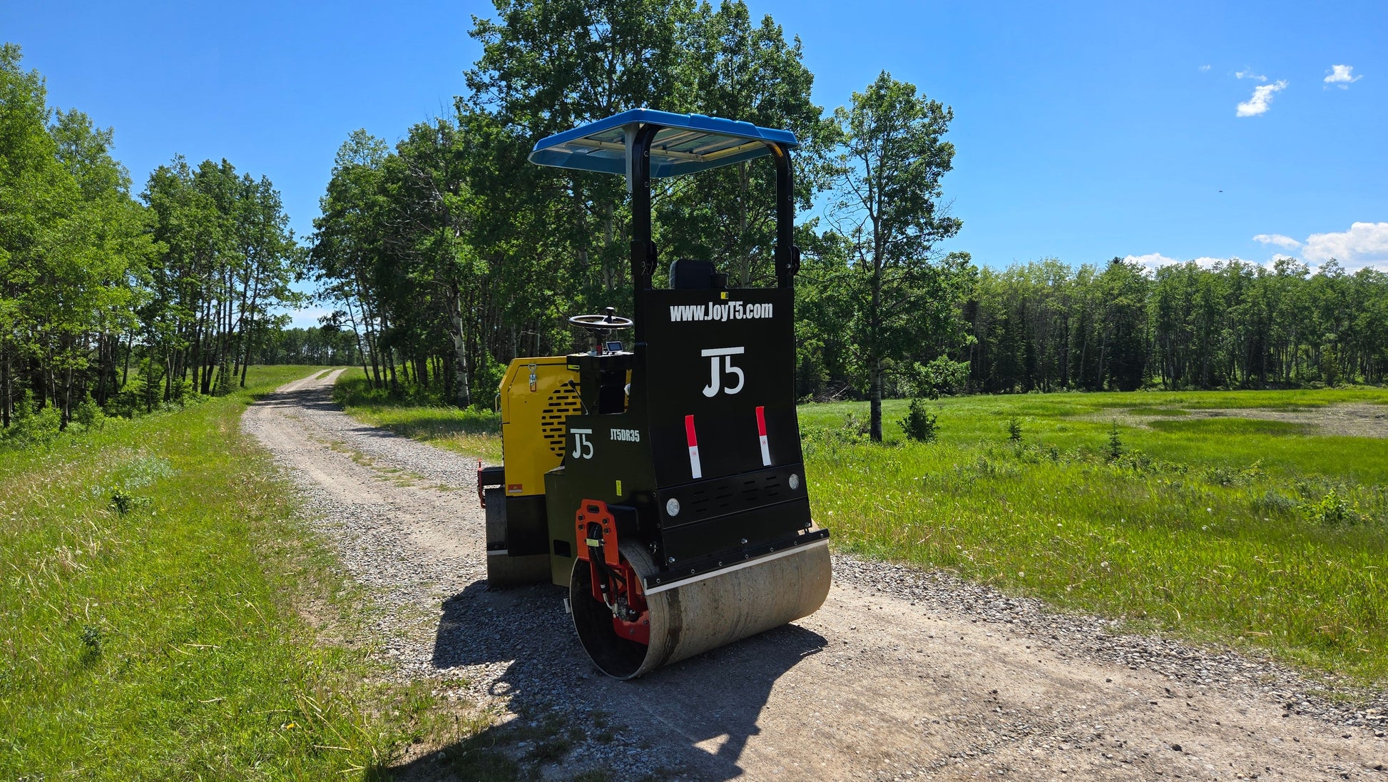 JT5DR35 vibratory drum roller working on a rural gravel road in Canada ideal soil compactor and road construction roller with Kohler engine