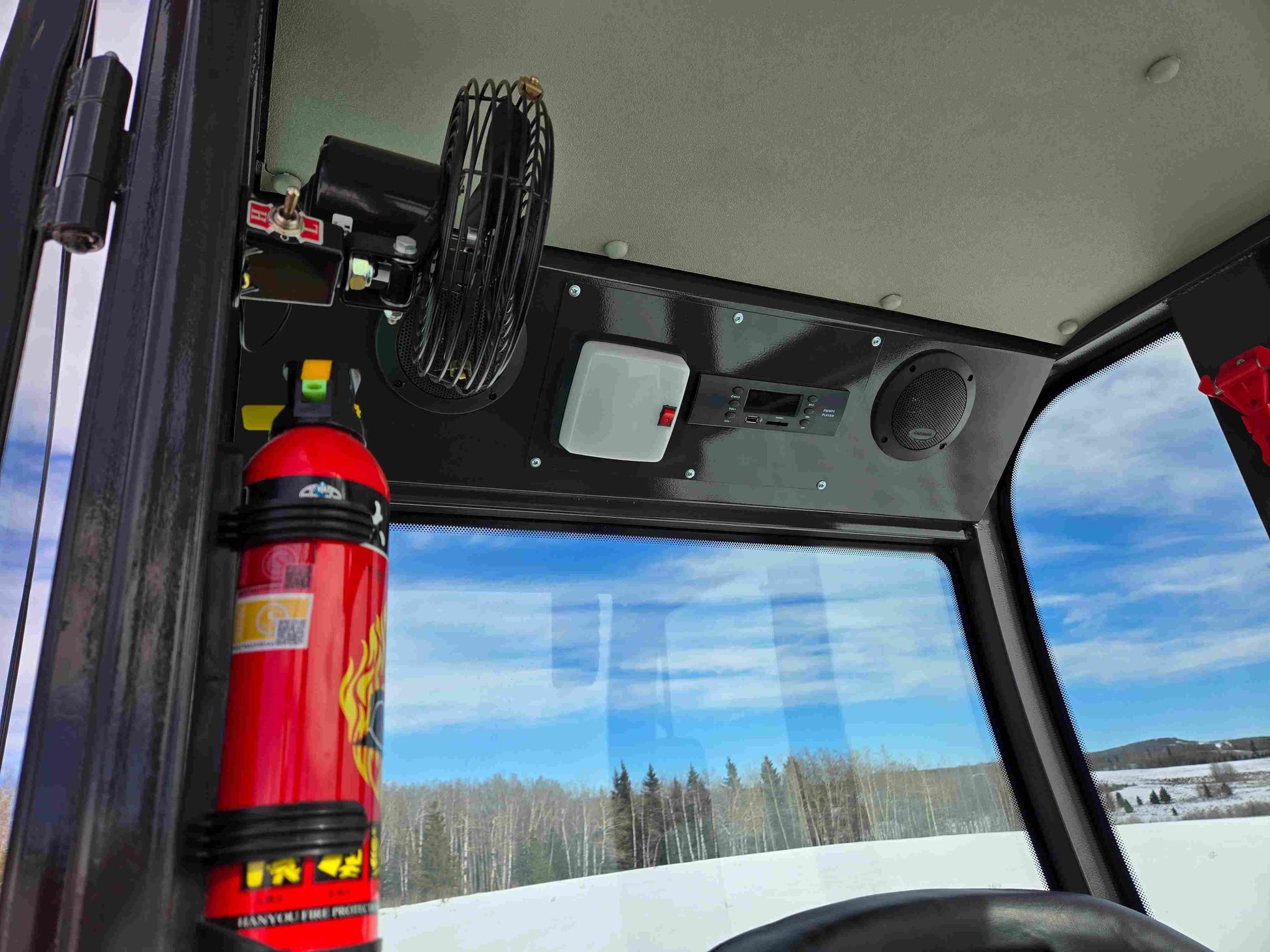 JT5WL1000 Compact Wheel Loader 1 Ton 2200 lbs for Sale Canada cabin interior with fire extinguisher, cooling fan, and control panel.