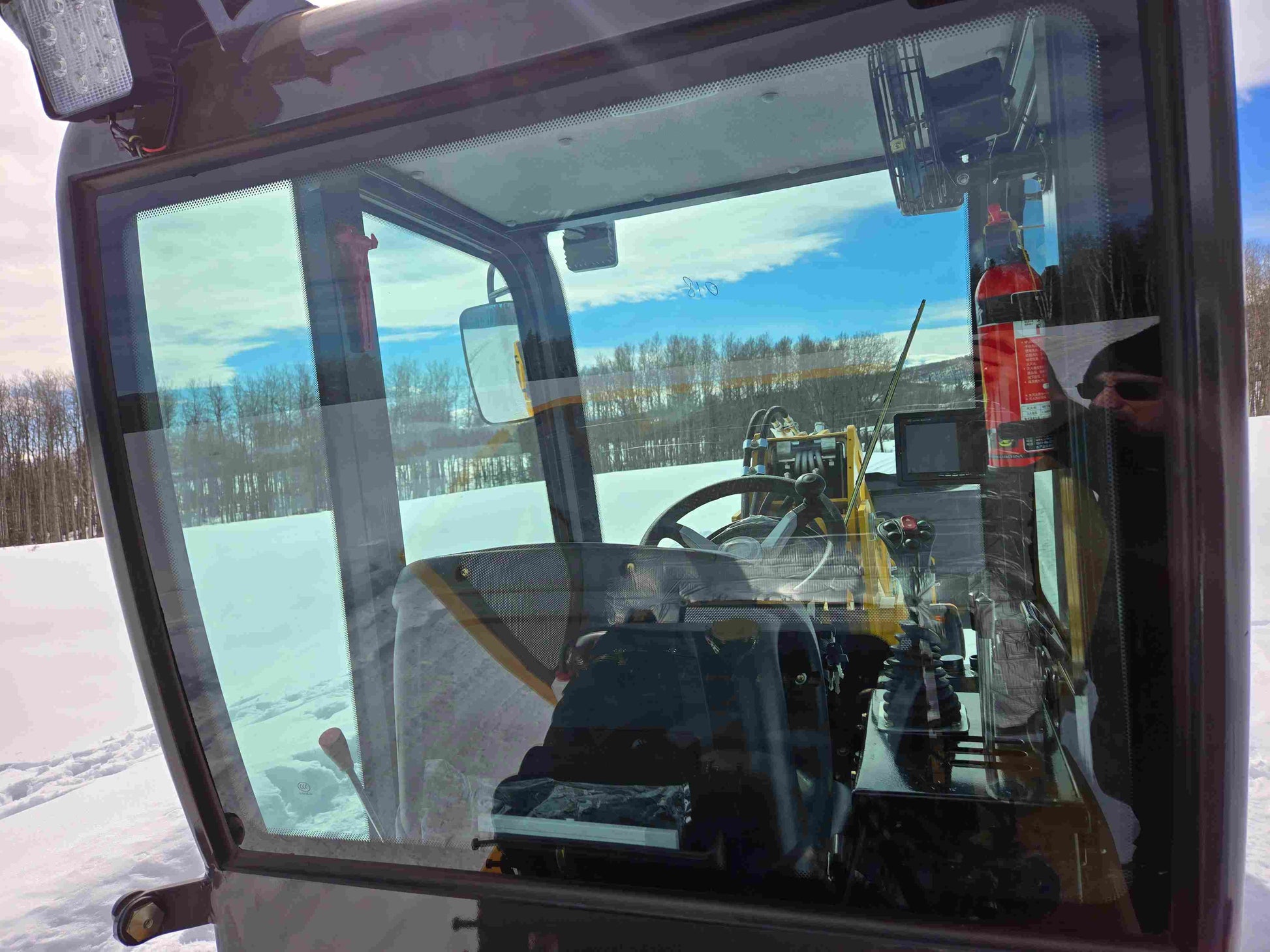 JT5WL1000 Compact Wheel Loader 1 Ton 2200 lbs for Sale Canada interior cabin view showing steering wheel, seat, and control levers.