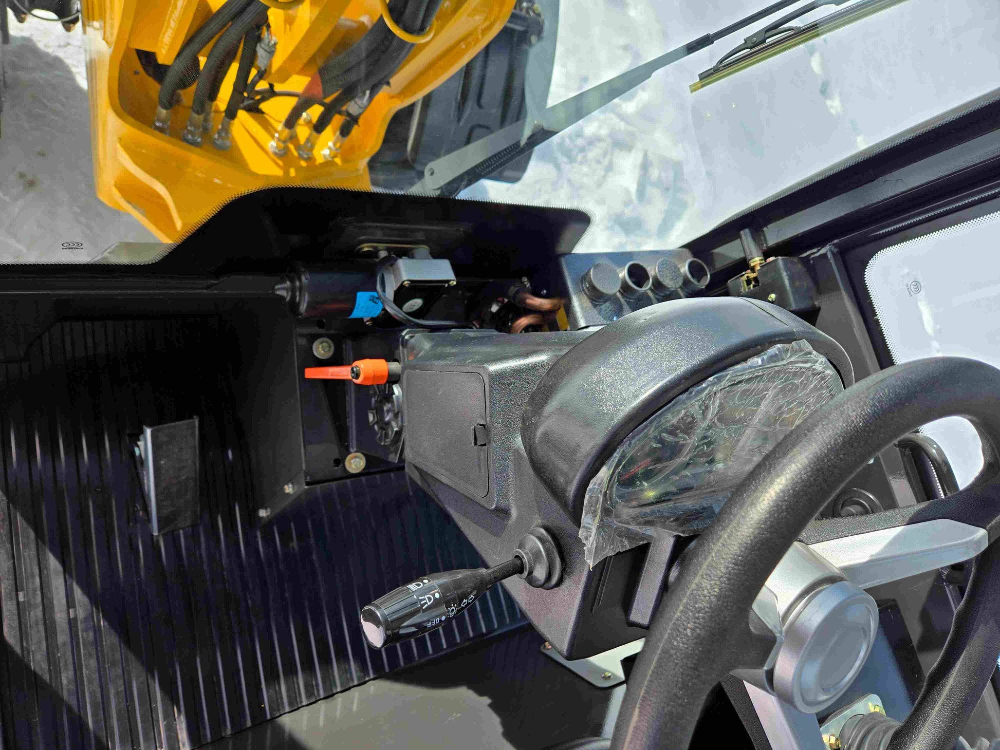 JT5WL1000 Compact Wheel Loader 1 Ton 2200 lbs for Sale Canada cabin view with steering wheel and dashboard controls.