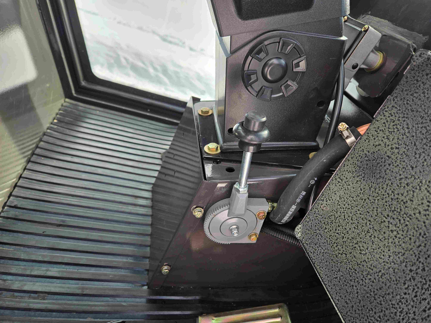JT5WL1000 Compact Wheel Loader 1 Ton 2200 lbs for Sale Canada showing detailed control lever and gear mechanism inside operator cabin.