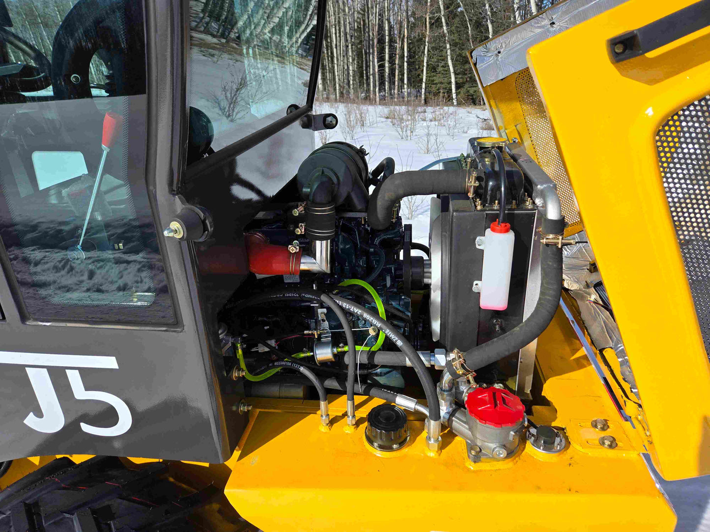 JT5WL1000 compact wheel loader 1 ton 2200 lbs for sale in Canada showing detailed engine compartment and internal components.