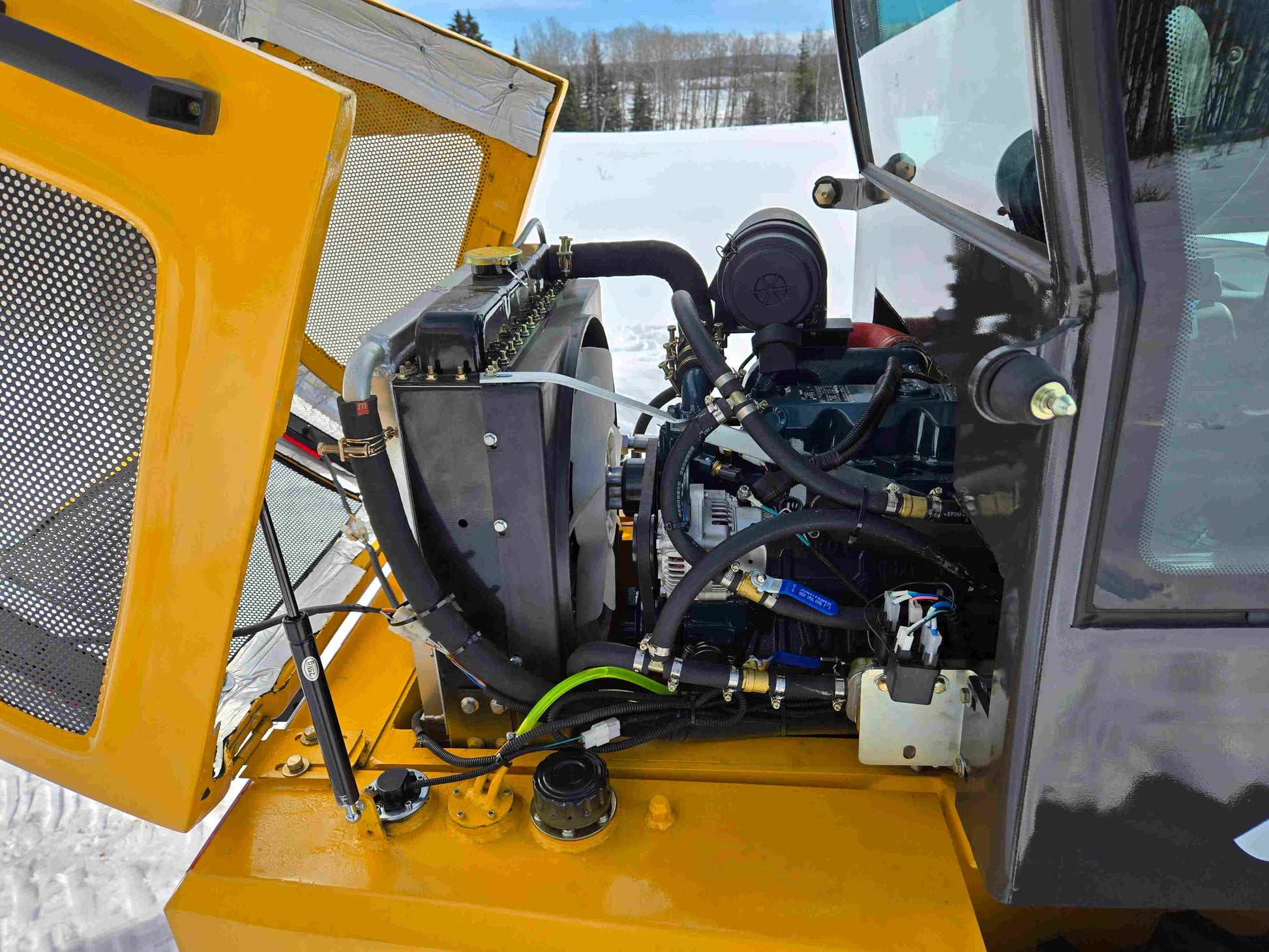 JT5WL1000 compact wheel loader 1 ton 2200 lbs for sale in Canada showing side view of engine and cooling system with hood open.