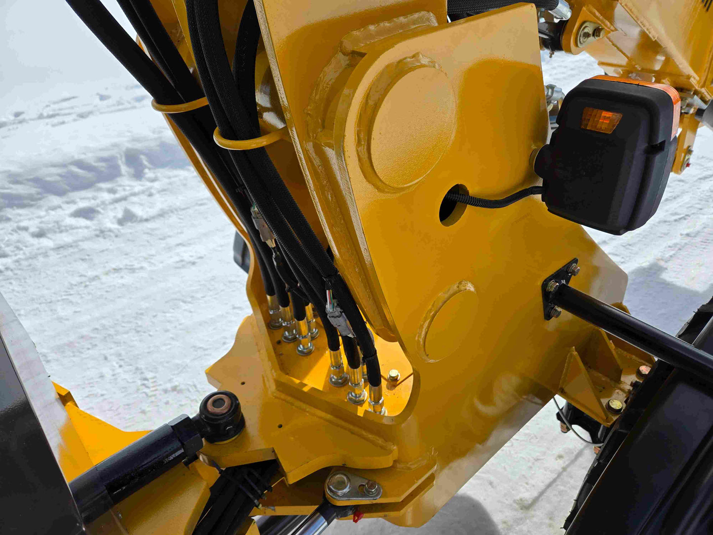 JT5WL1000 compact wheel loader hydraulic joint closeup for construction and farm use in snowy Canada showcasing durability and heavy duty performance