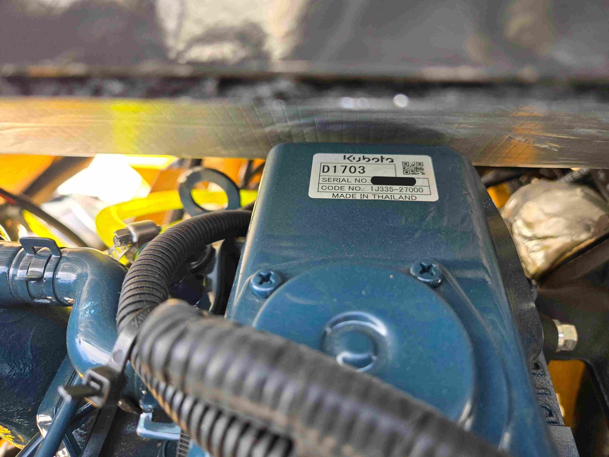 JT5WL1000 compact wheel loader 1 ton 2200 lbs for sale in Canada showing Kubota engine serial number and code label made in Thailand.