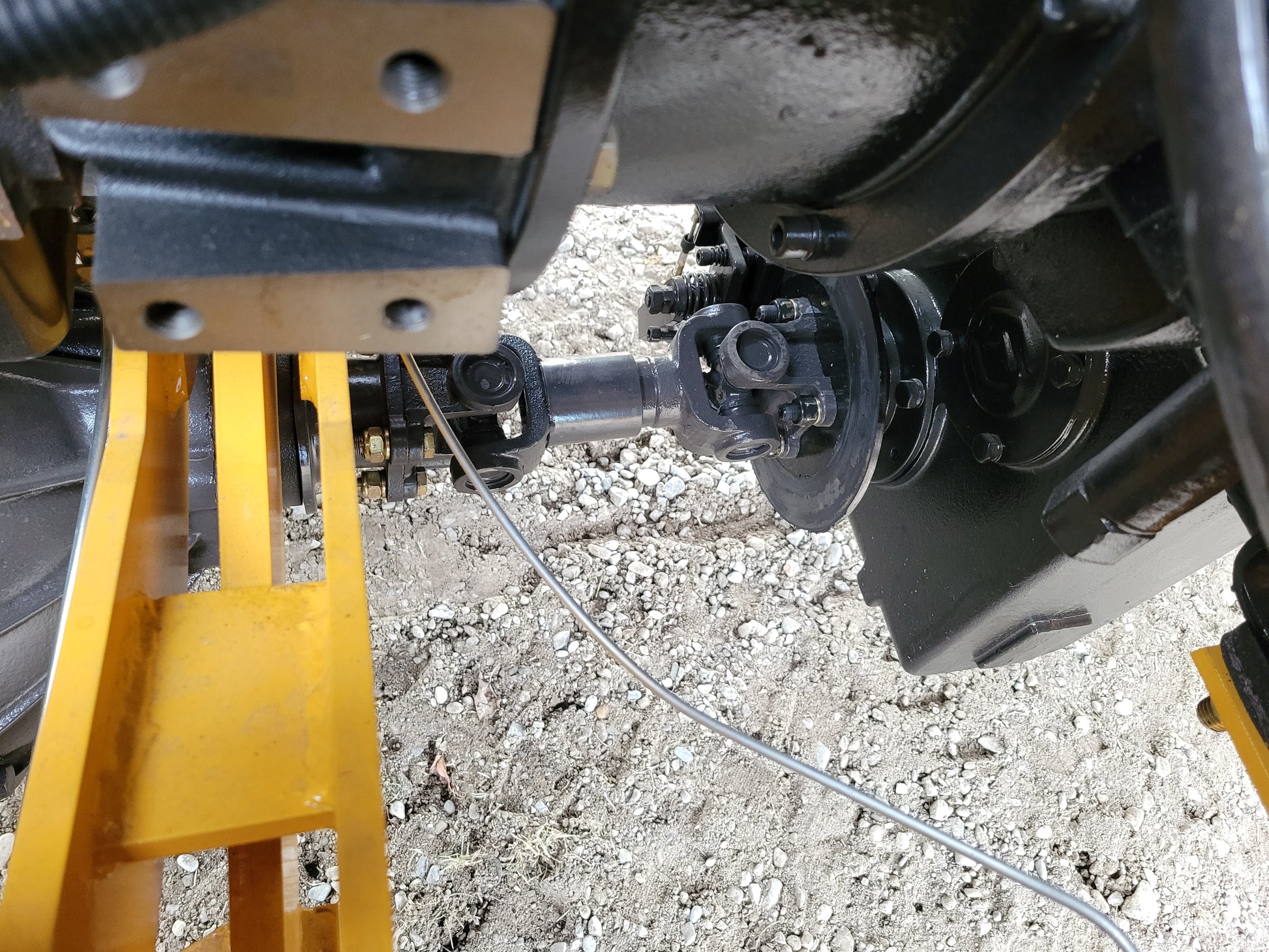 JT5WL1200 compact wheel loader drivetrain and axle system showing hydraulic connection for heavy duty construction work in Canada