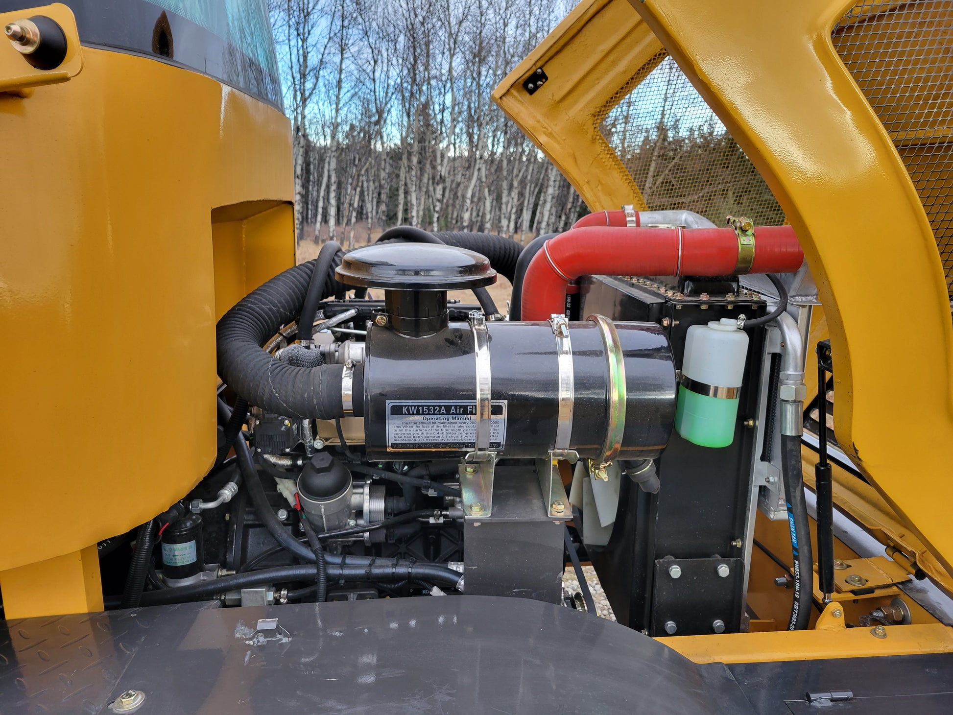 JT5WL1200 compact wheel loader engine compartment showing air filter cooling system and hydraulic components for heavy duty construction work in Canada
