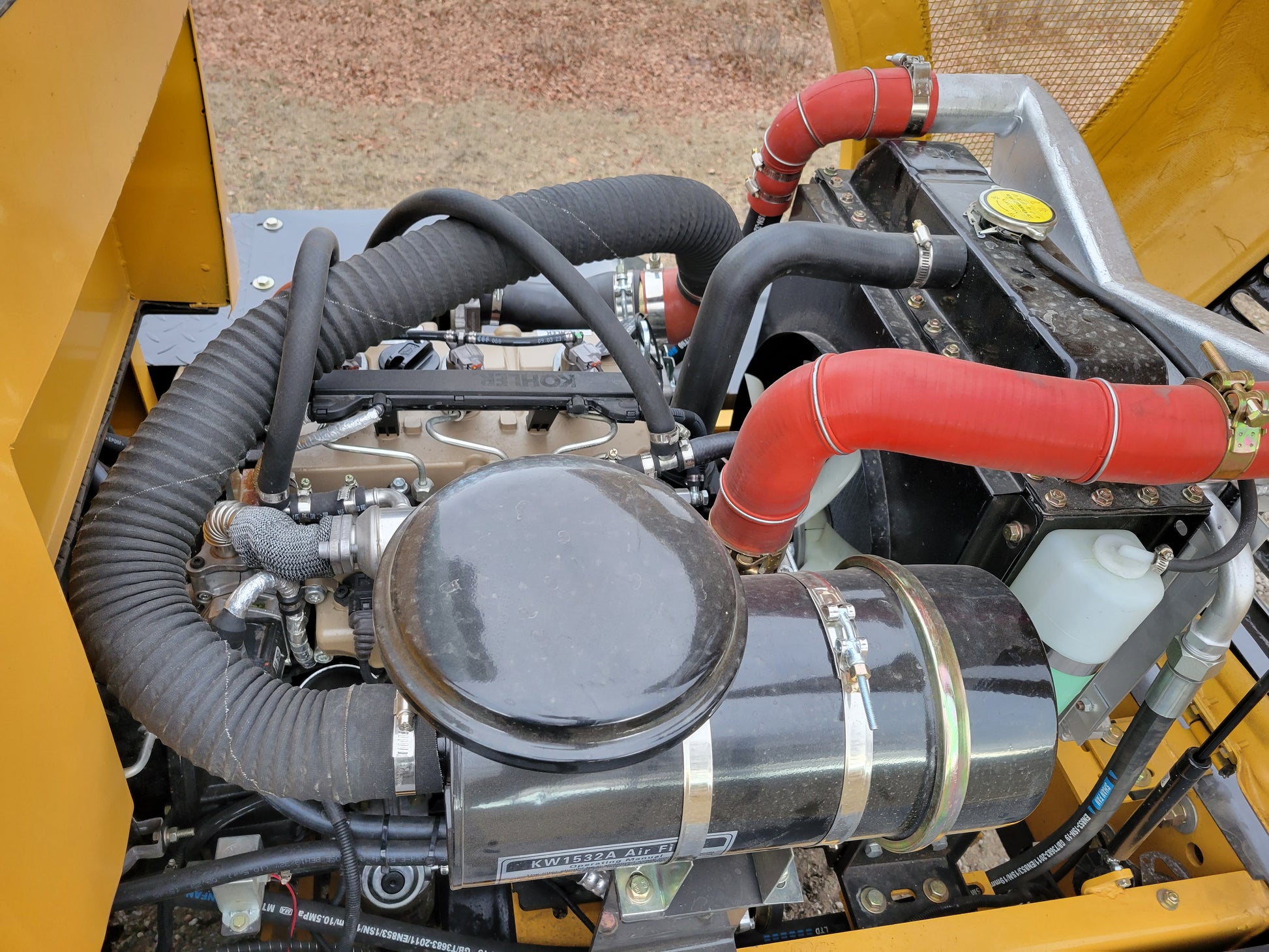 JT5WL1200 compact wheel loader 1.2 ton 2650 lbs engine compartment with Kohler diesel engine and radiator hoses for farm and construction use in Canada