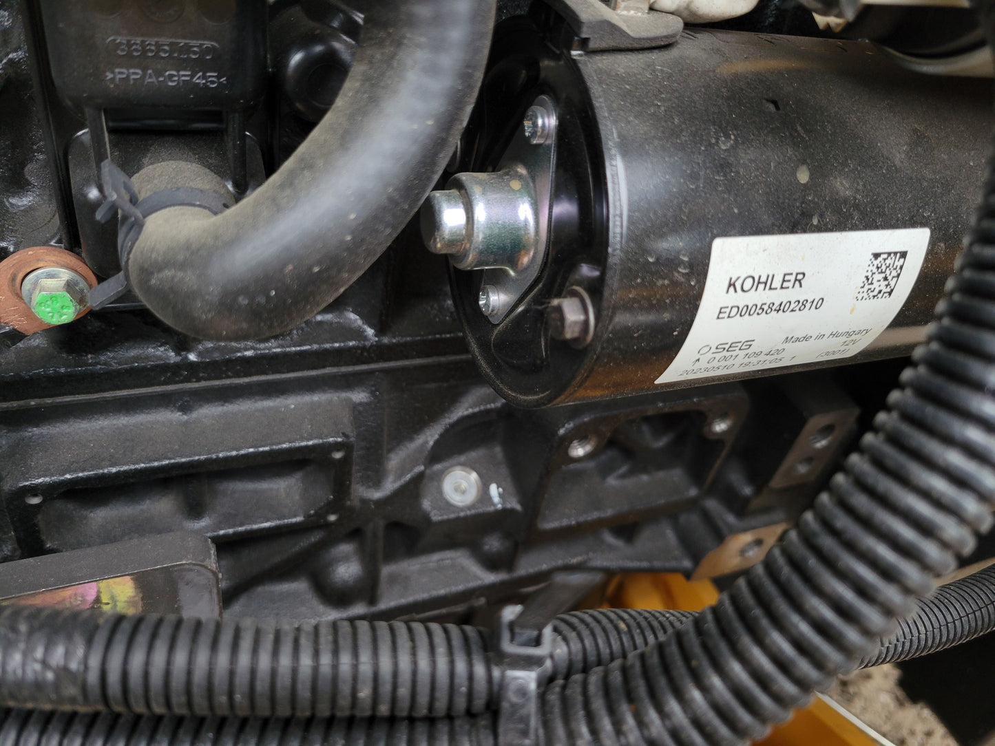 JT5WL1200 compact wheel loader engine component closeup showing power system and wiring details for reliable construction use in Canada