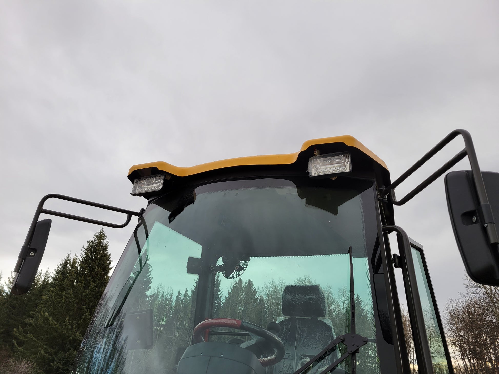 JT5WL1200 compact wheel loader front cabin with LED work lights and wide mirrors for safe operation in Canada