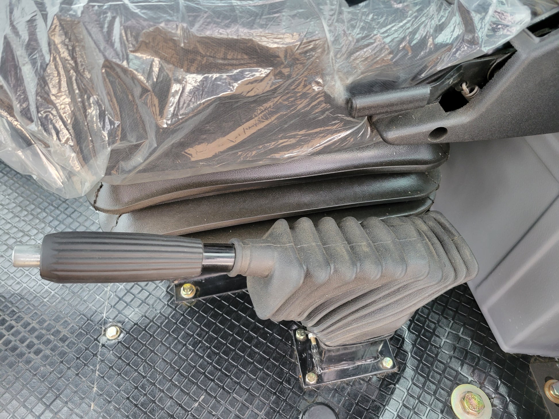 JT5WL1200 compact wheel loader handbrake and lever control beside operator seat for safe operation in Canada