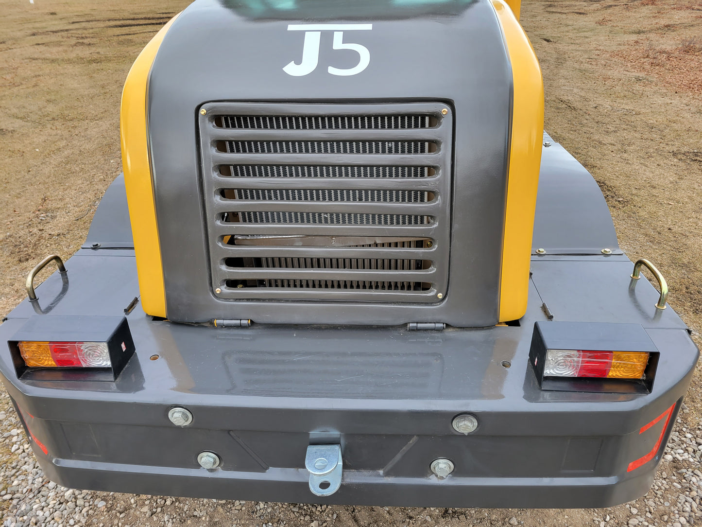 Rear view of JT5WL1200 wheel loader showing engine grill, taillights, and towing hook.