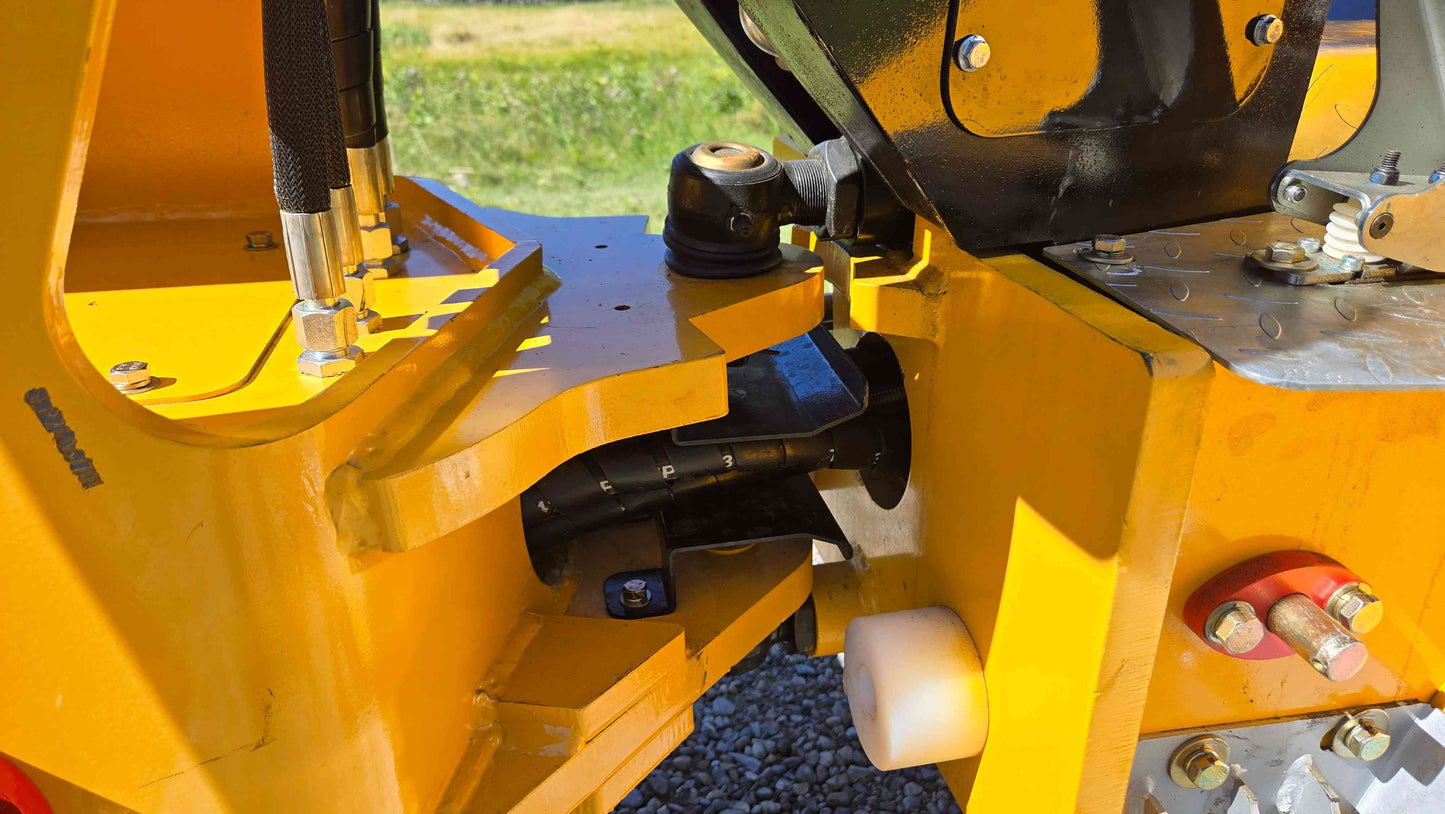 Center articulation joint of the JT5WL800 compact wheel loader showing the steering connection and hydraulic lines used for farm landscaping and construction work in Canada