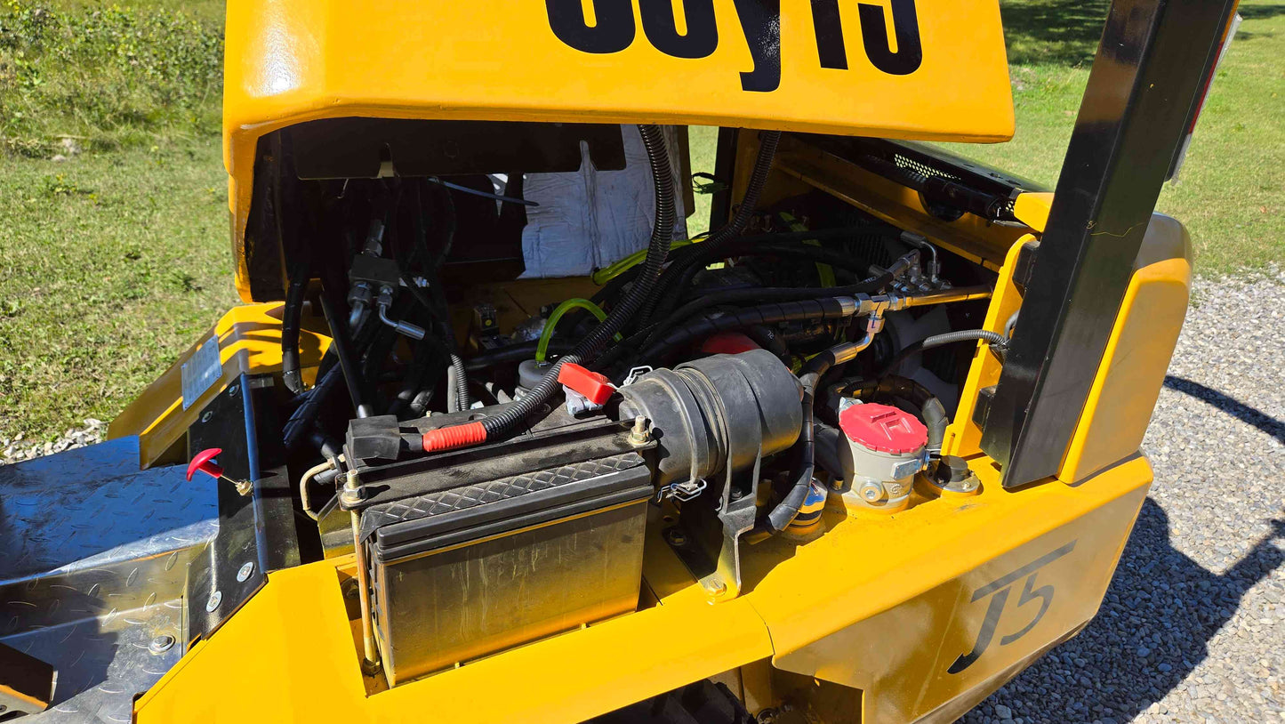 Open engine bay of the JT5WL800 compact wheel loader showing the battery hydraulic hoses and electrical components arranged for easy farm landscaping and construction work across Canada