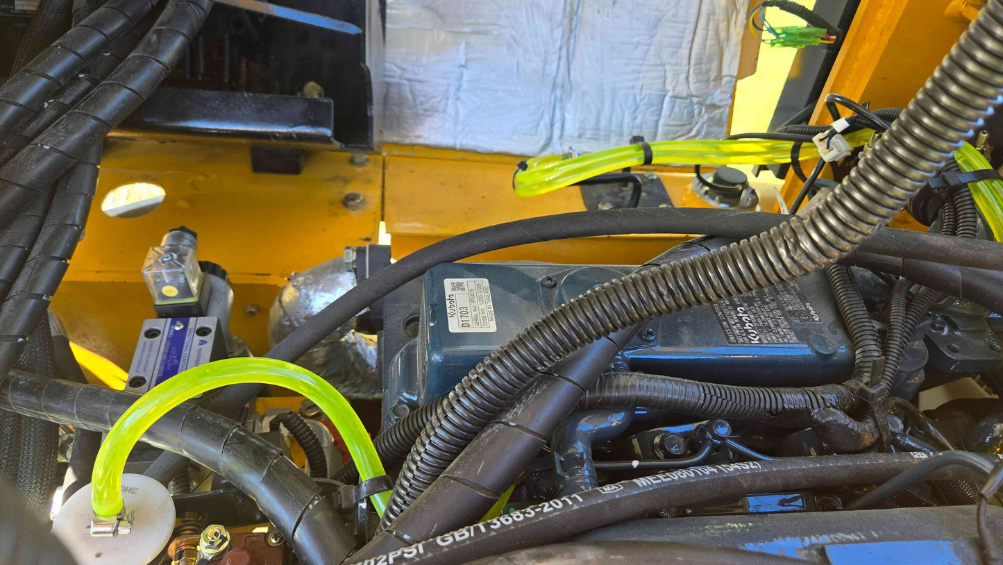 Engine wiring harness fluid lines and control module inside the JT5WL800 compact wheel loader shown in a detailed close view for dependable farm landscaping and construction work across Canada