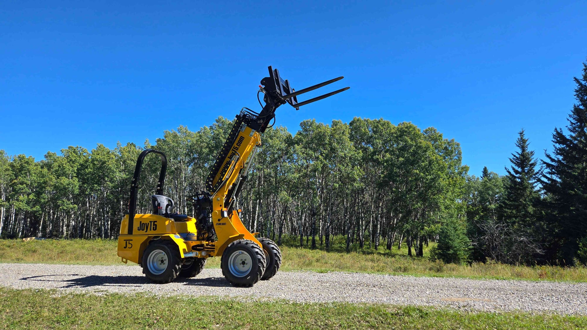 JT5WL800 compact wheel loader showing forklift lifting operation for landscaping farming and construction work in Canada
