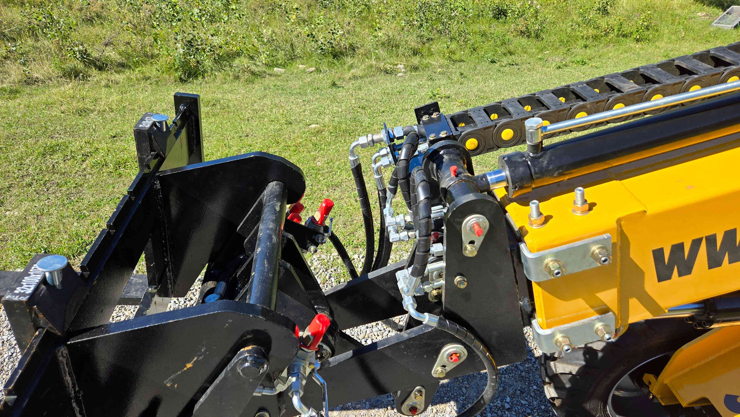 Hydraulic attachment system of the JT5WL800 compact wheel loader used for landscaping and construction work in Canada with visible hoses couplings and loader arm