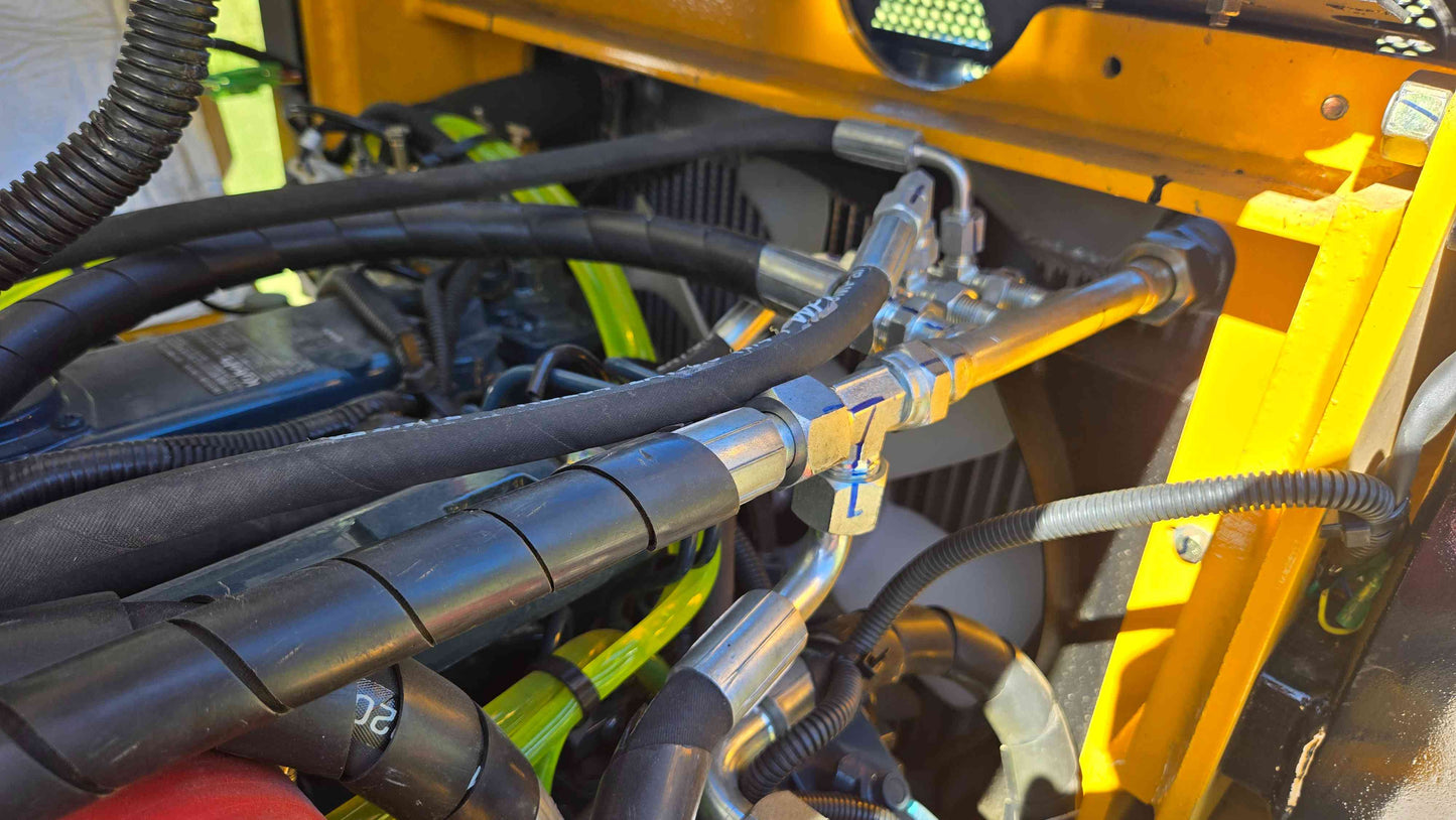 JT5WL800 compact wheel loader hydraulic hose system and metal fittings showing engine-side fluid routing for farm landscaping and construction use across Canada