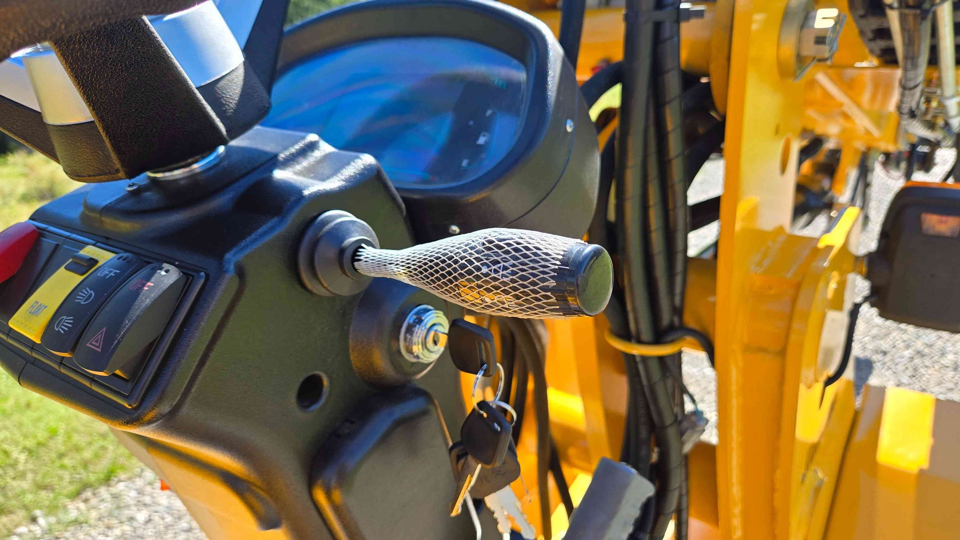 Ignition key steering column and control switches of the JT5WL800 compact wheel loader showing a close view of the operating controls used for farm landscaping and construction work across Canada