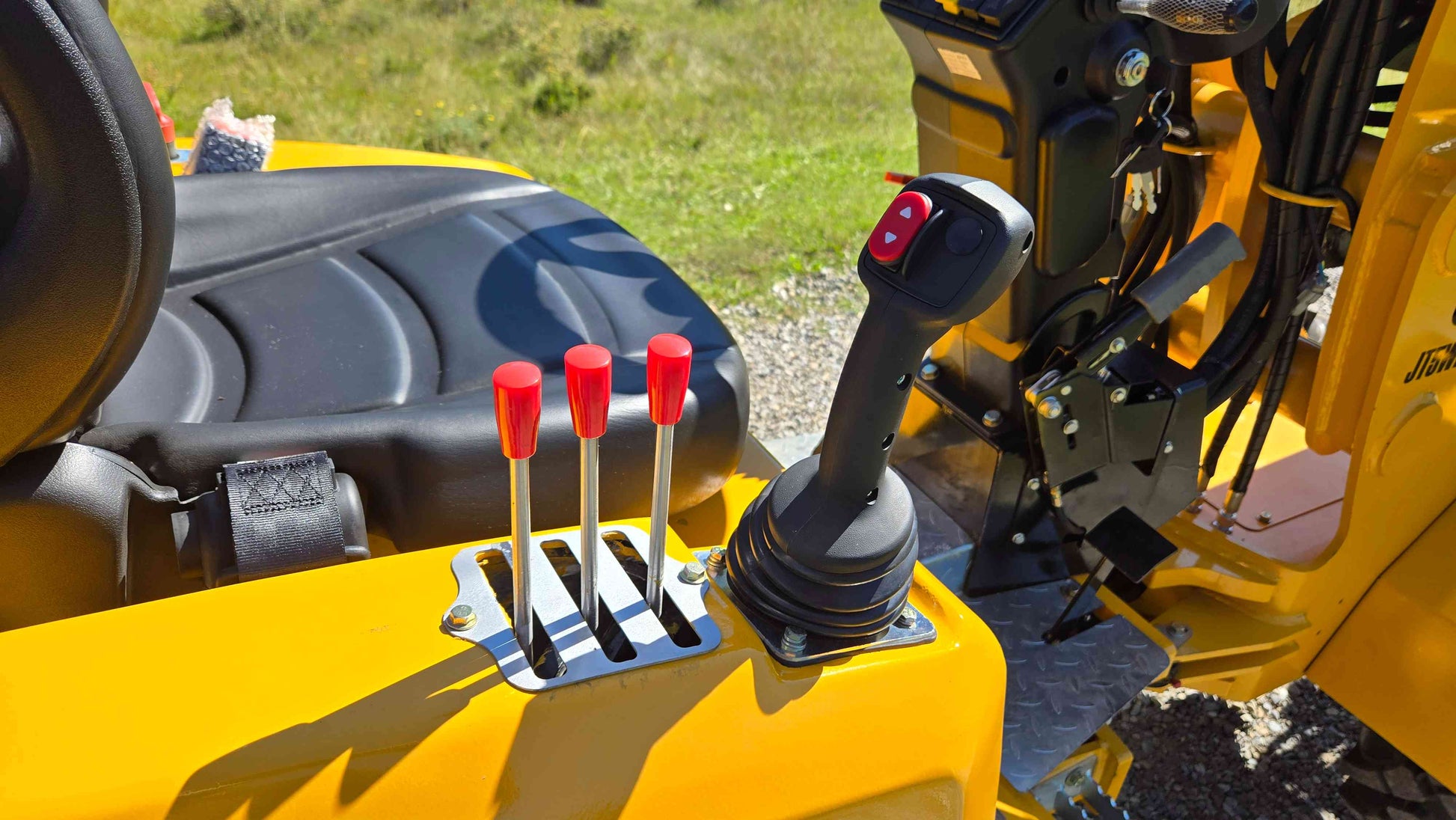 Joystick and hydraulic control levers beside the operator seat on the JT5WL800 compact wheel loader designed for smooth handling in farm landscaping and construction work across Canada
