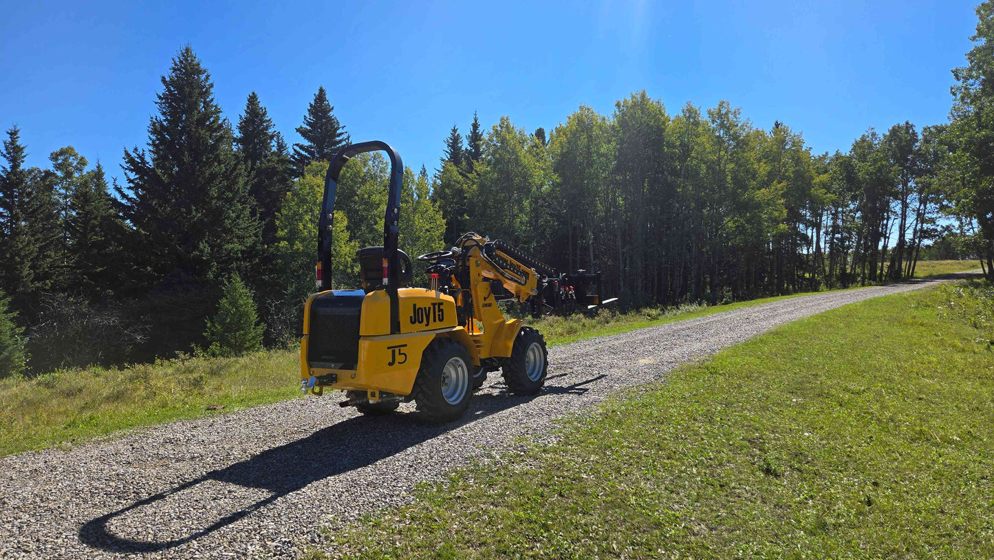 JT5WL800 compact wheel loader on country road ready for farming landscaping and construction tasks in Canada