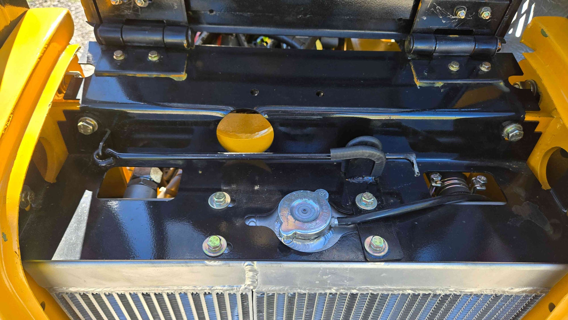 JT5WL800 compact wheel loader radiator cap and upper frame section displayed for buyers in Canada looking for reliable compact construction equipment