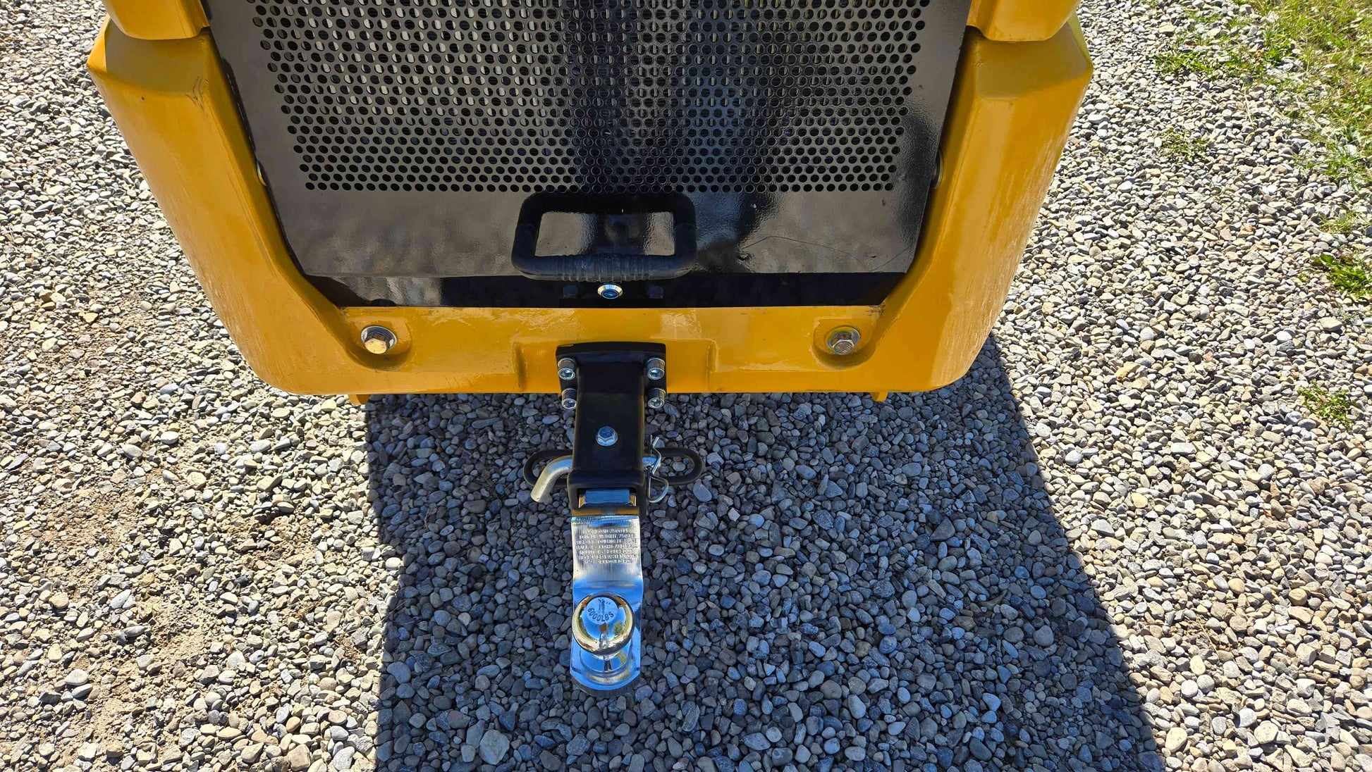 Rear towing hitch of the JT5WL800 compact wheel loader shown on gravel ground ready for hauling and utility work for farms landscaping and construction projects in Canada