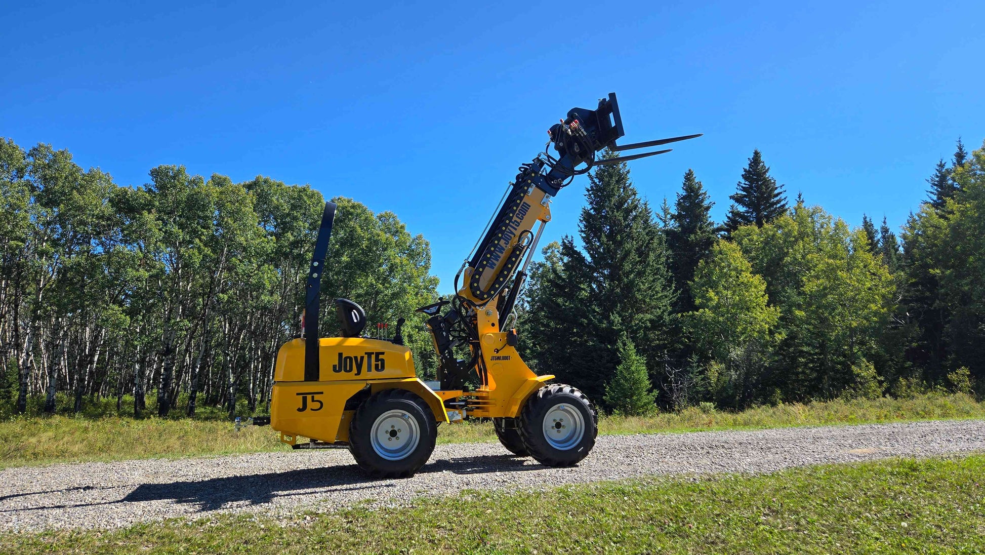 JT5WL800 compact wheel loader with telescopic forklift attachment lifting high for construction and farm use in Canada

